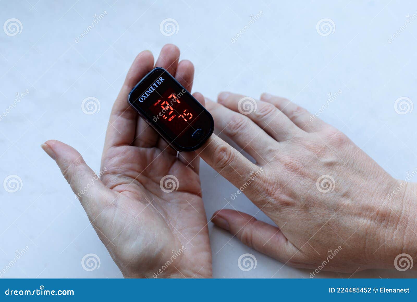 measuring of oxygen level in blood with home oximeter, oximeter in woman`s hands