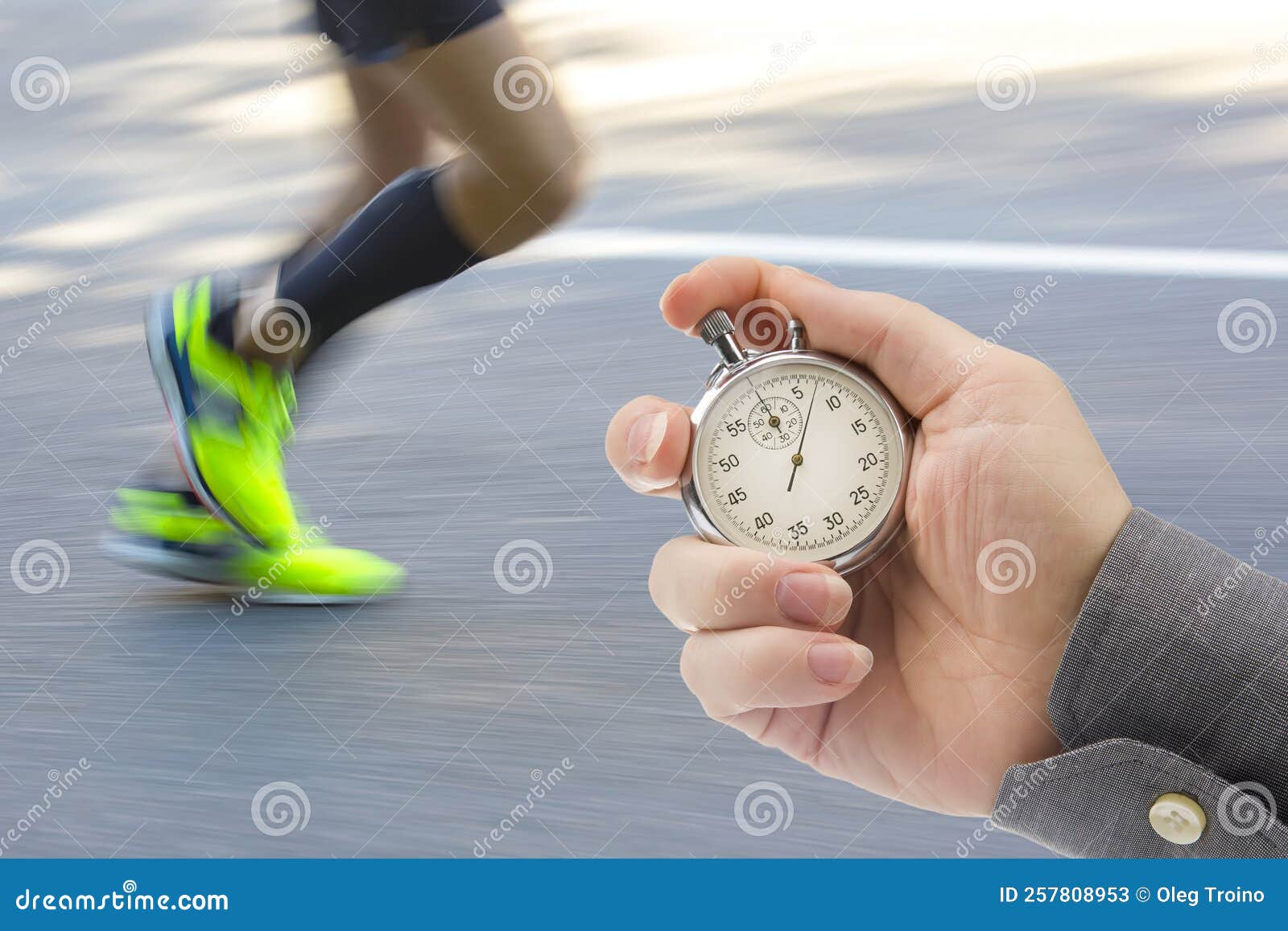 Measuring the Running Speed of an Athlete Using a Mechanical Stopwatch.  Hand with a Stopwatch on the Background of the Legs of a Stock Image -  Image of chronometer, monitor: 257808953