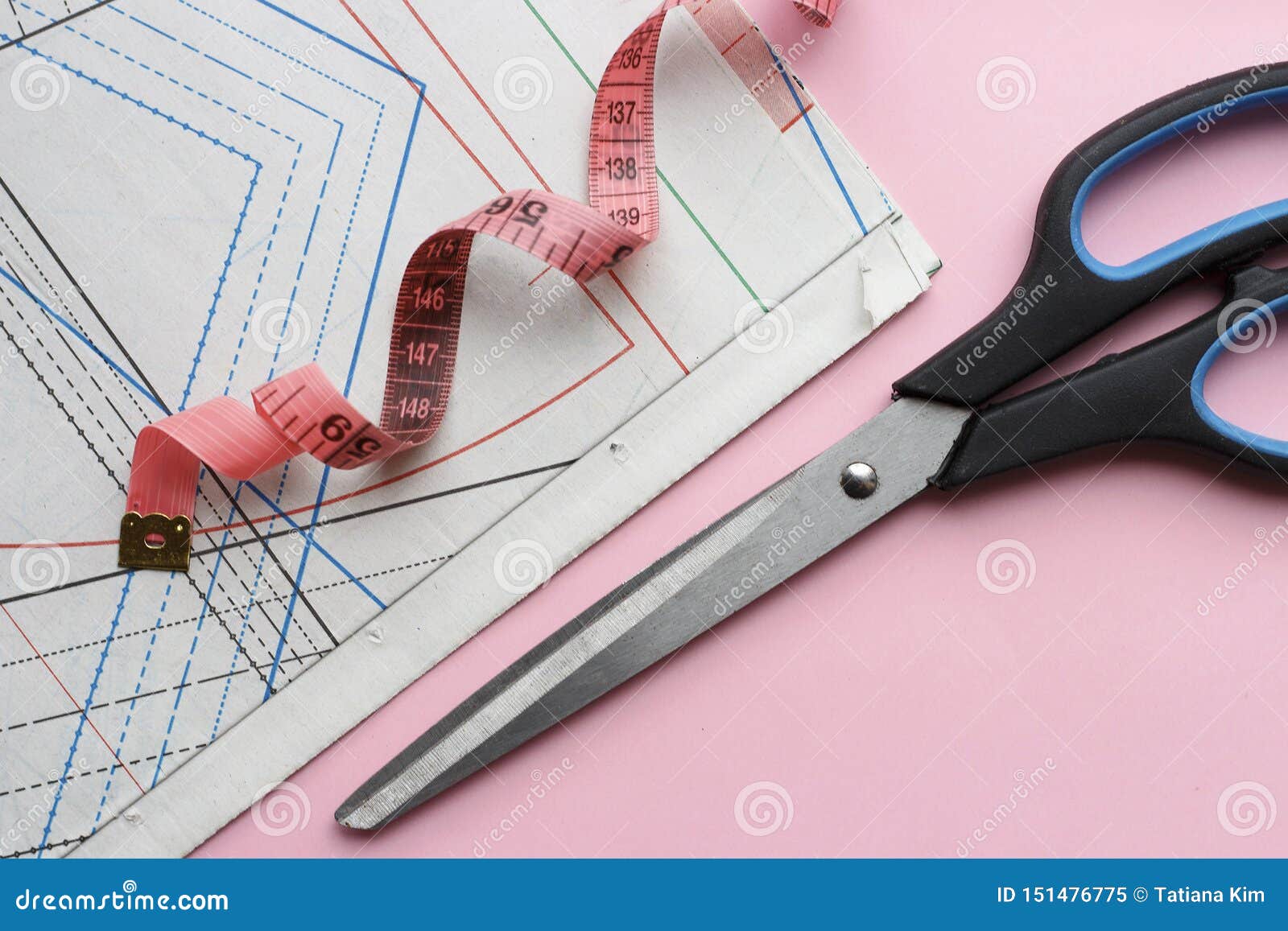 Measuring Tape, Scissors and Sewing Pattern for Sewing on a Pink