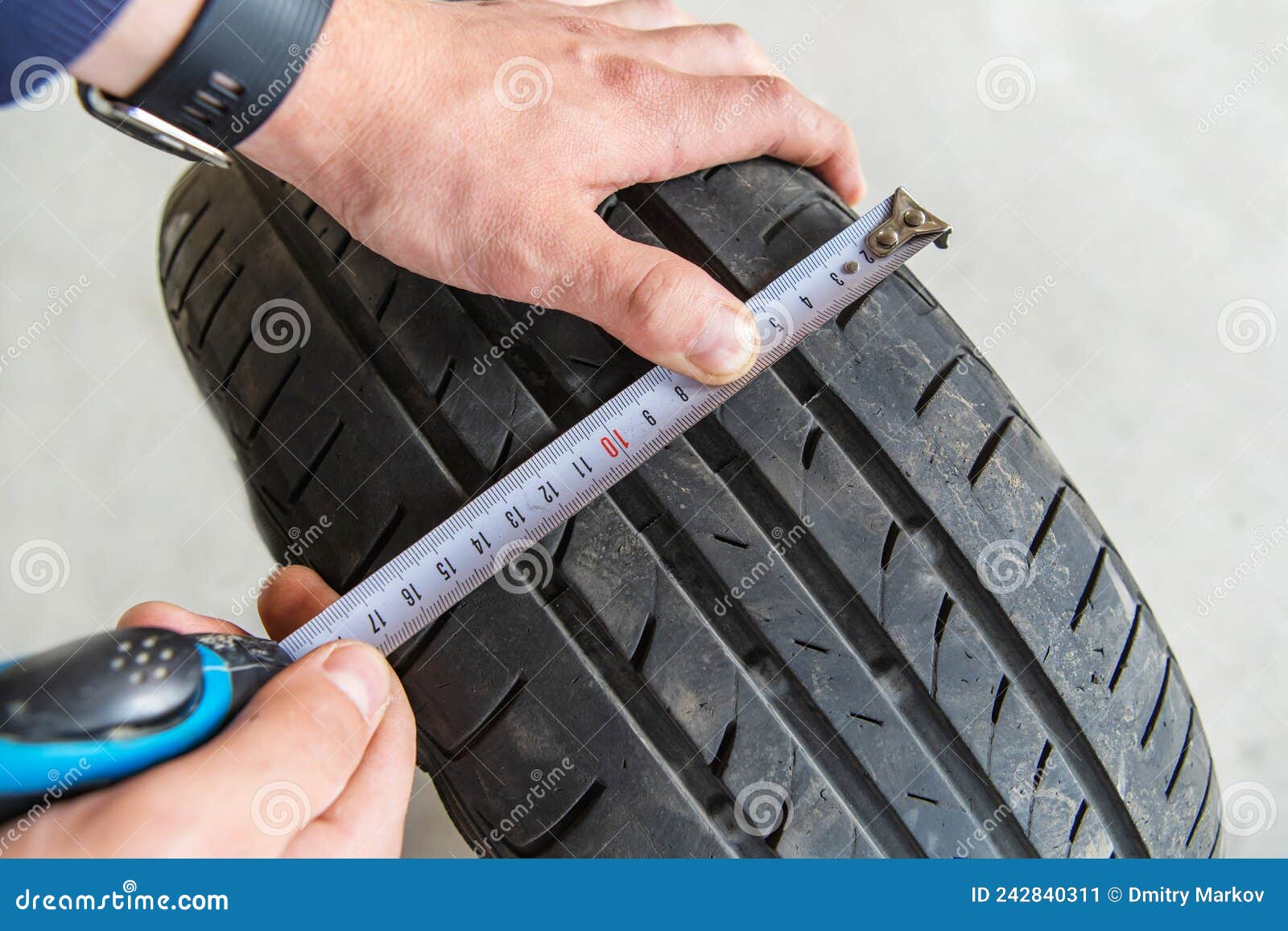Measuring the Tire Tread with a Tape Measure. Worn Tire Technical Check