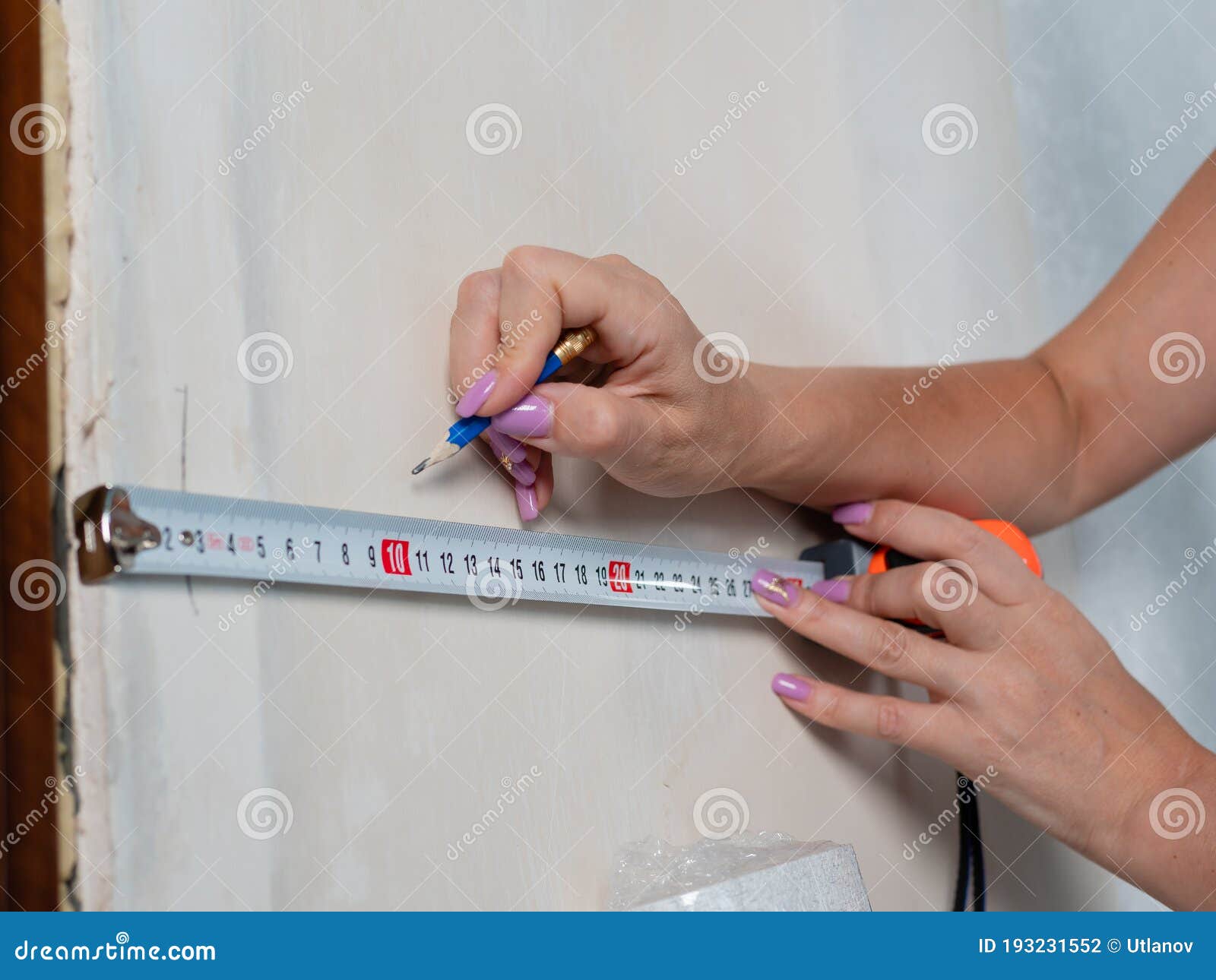 Measuring the Walls in the Room before Pasting Wallpaper, Closeup