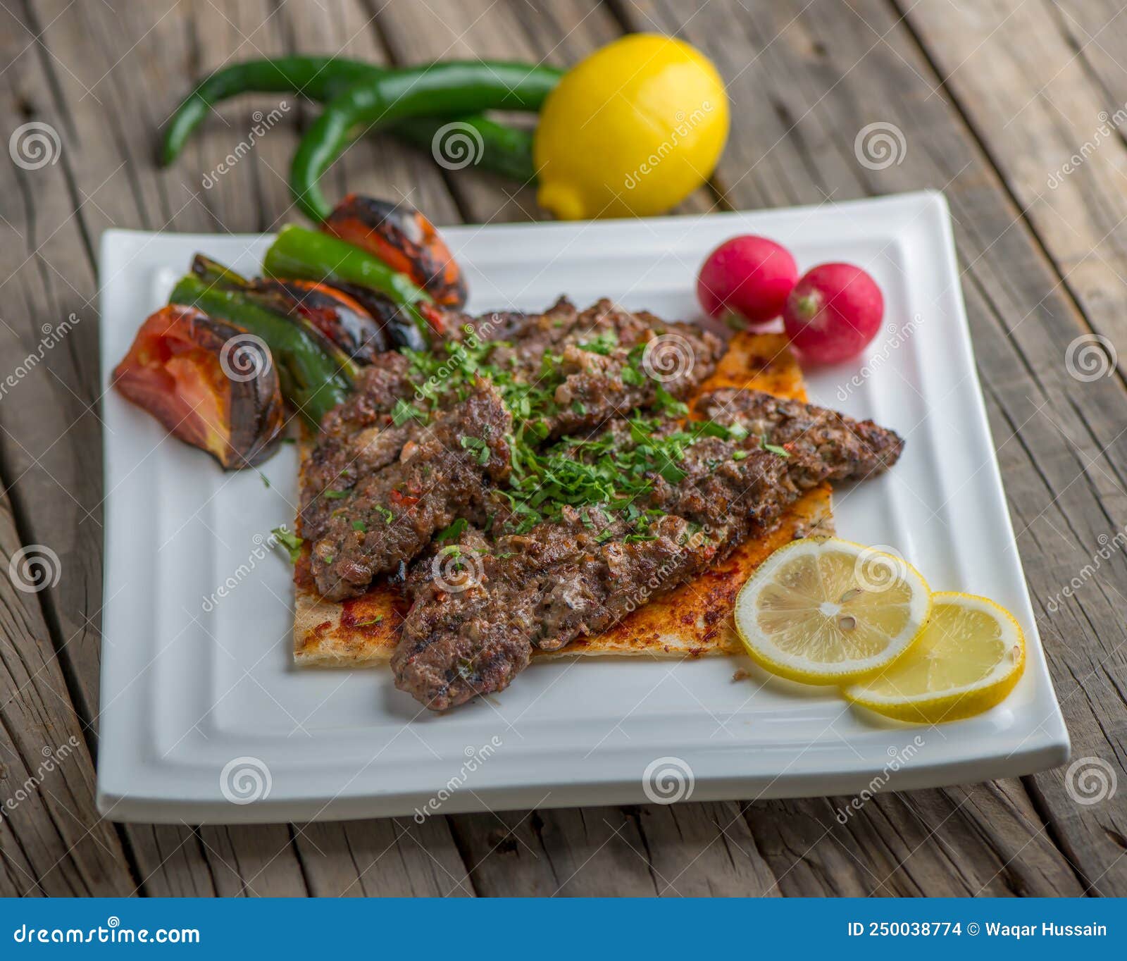 Meat Halabi Kebab Served in a Dish Side View on Wooden Table Background