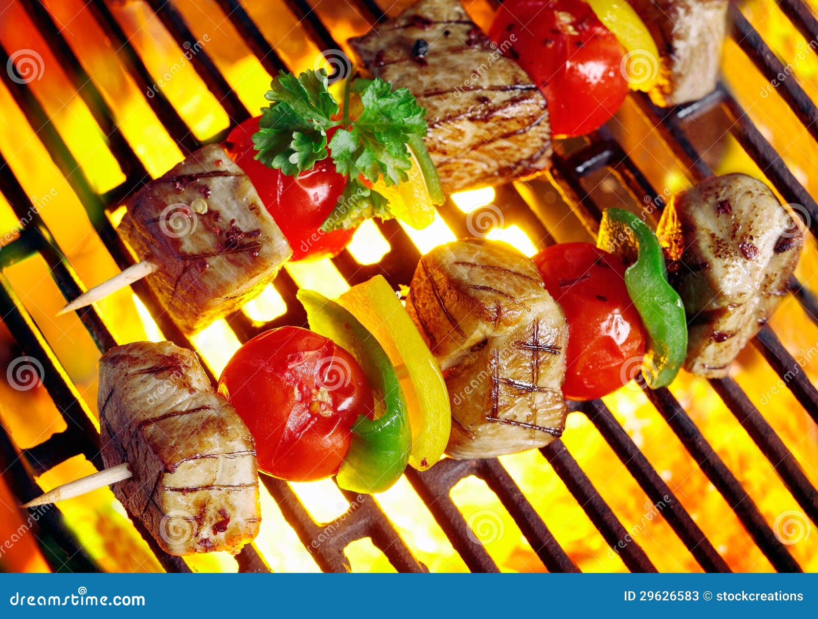 meat kebabs sizzling over the coals