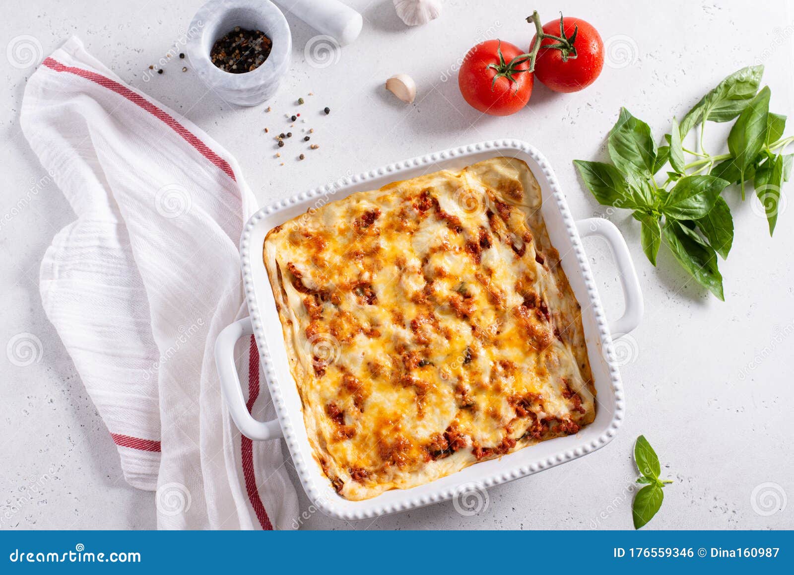 Meat Lasagna on a White Background with Fresh Basil and Tomatoes. Top ...
