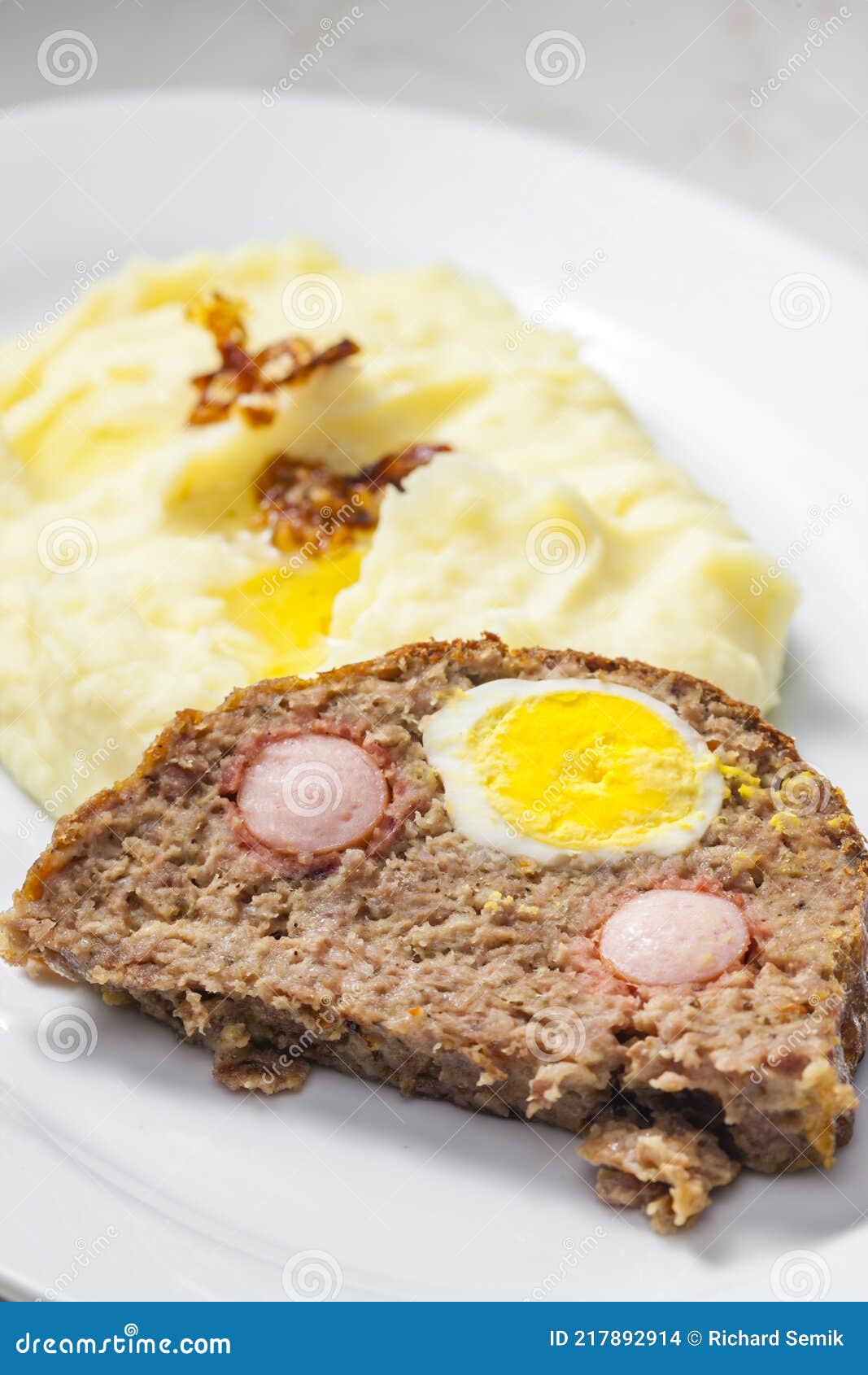 Meat Loaf Filled with Egg and Sausage Served with Mashed Potatoes and