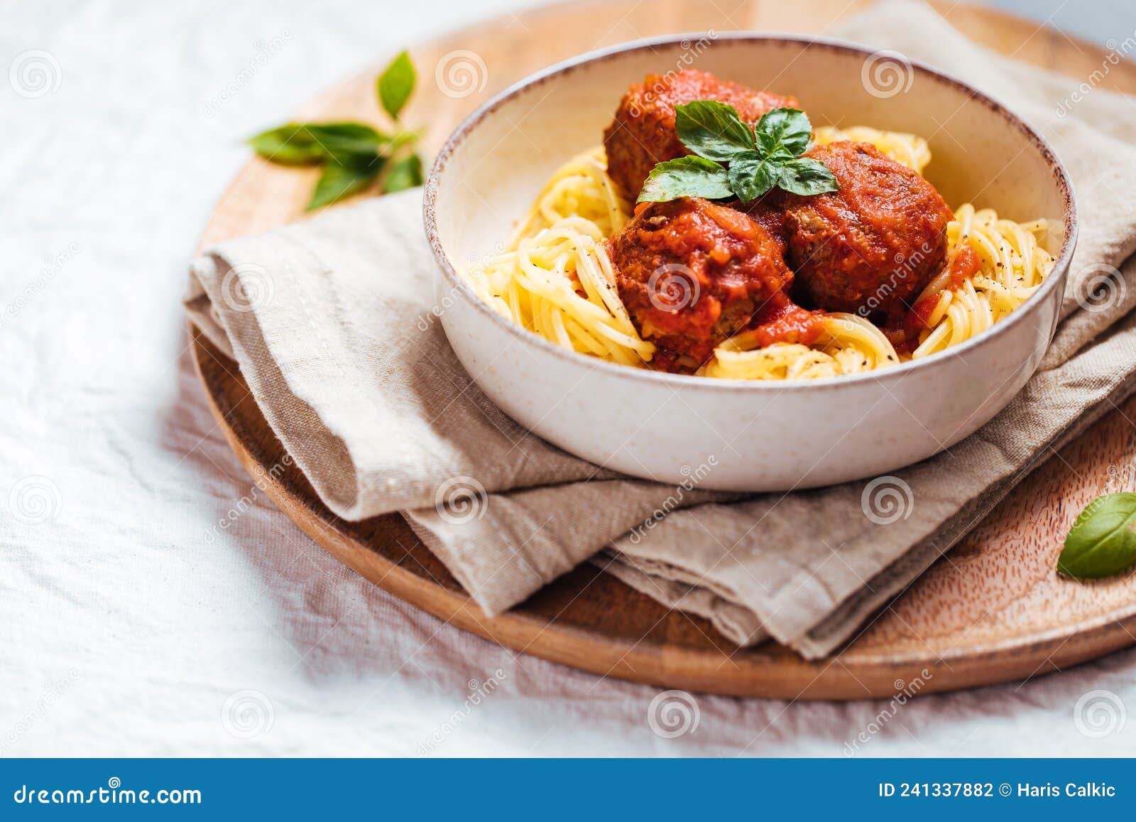 meatballs in tomato sauce with ingredients in bakground.