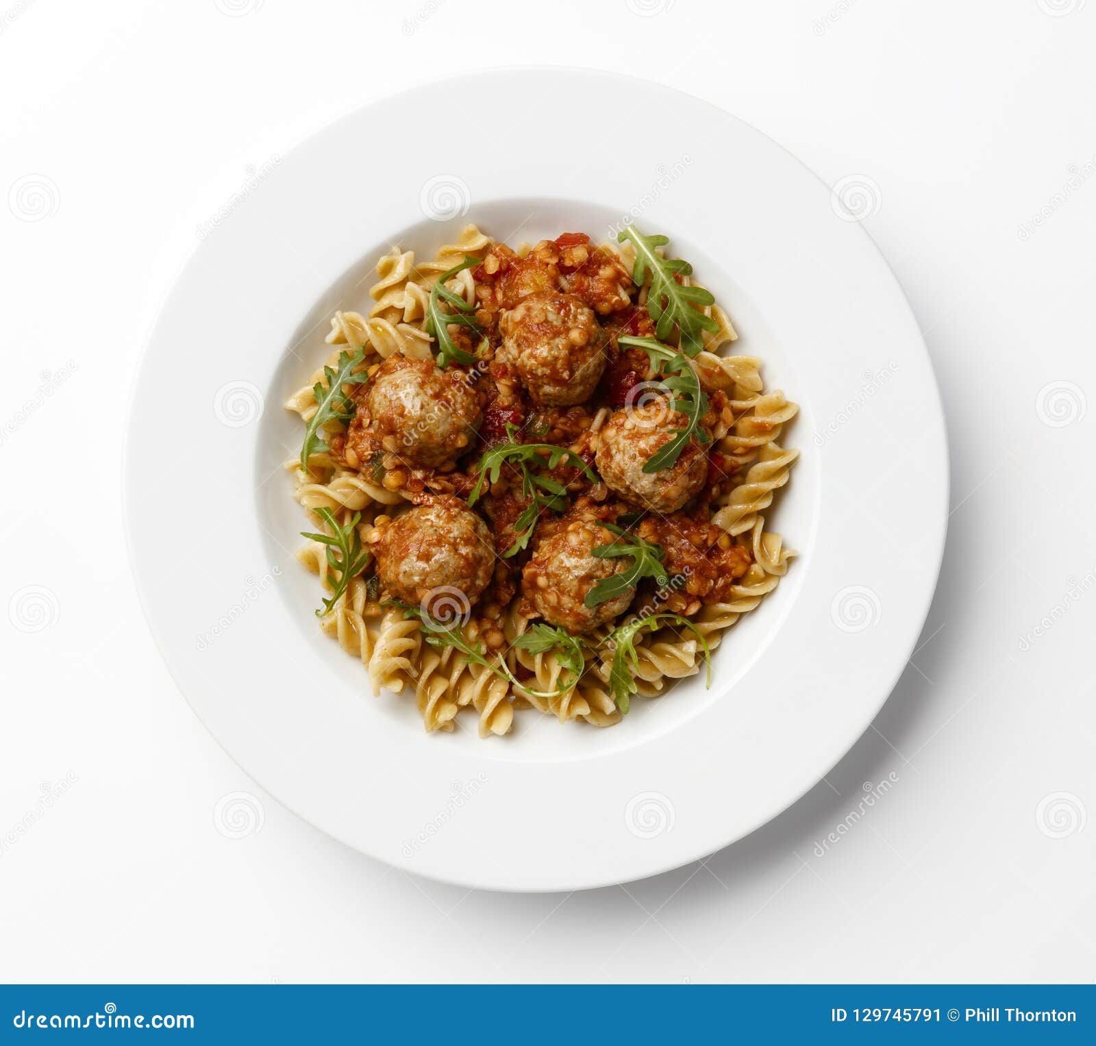 Meatballs in a Tomato Sause with Paste Twists with a Rocket Garnish, on