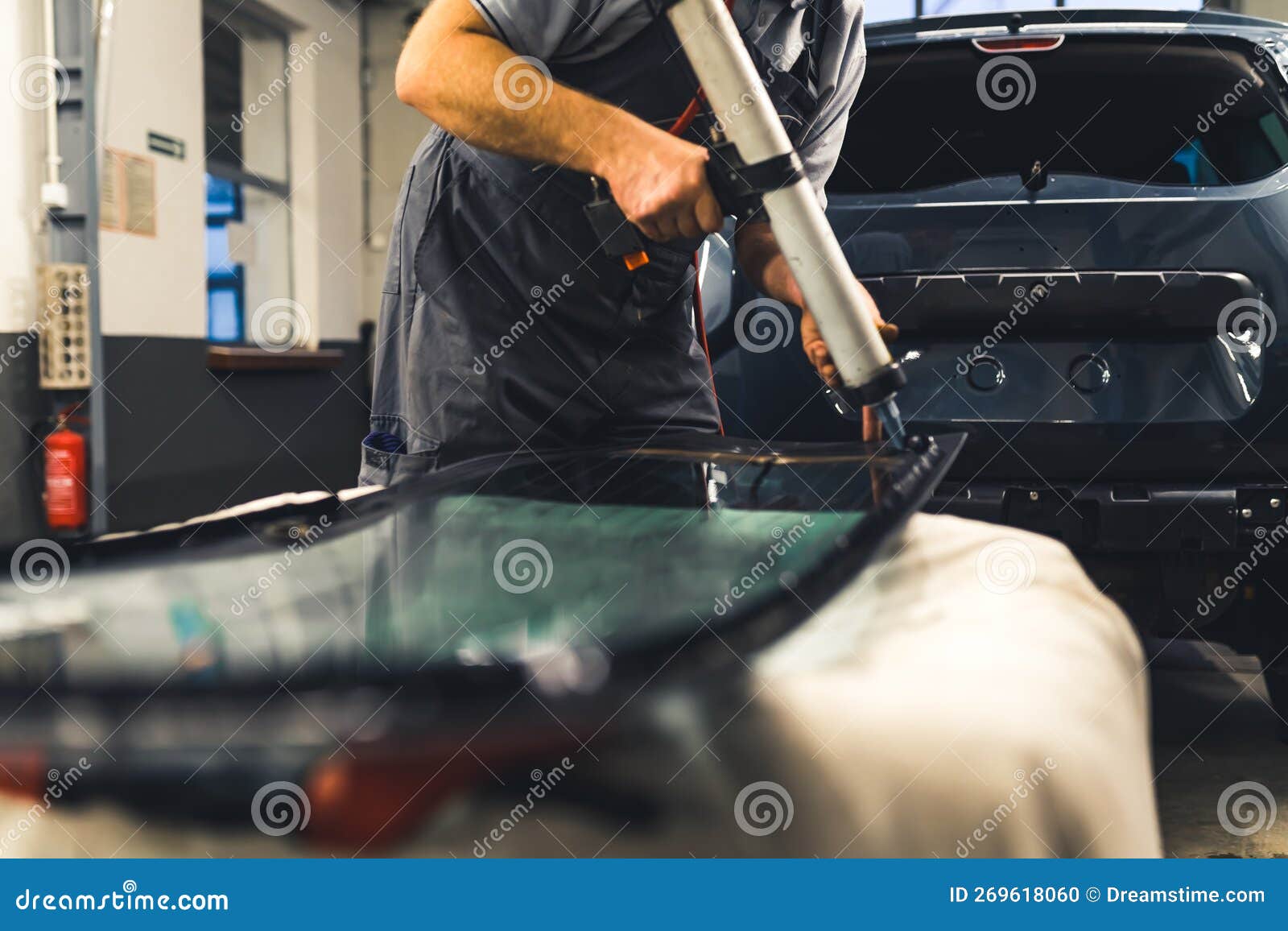 Mechanic Adding Glue To the Windscreen of a Car Windshield Replacement