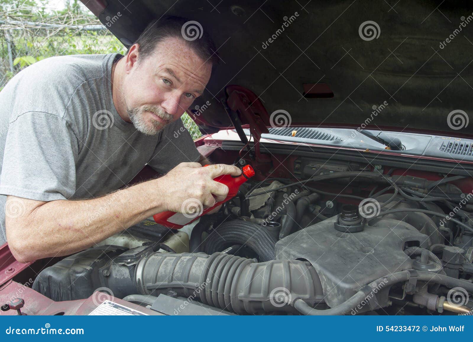 Mechanic Adding Oil To Older Truck Stock Photo Image of shop