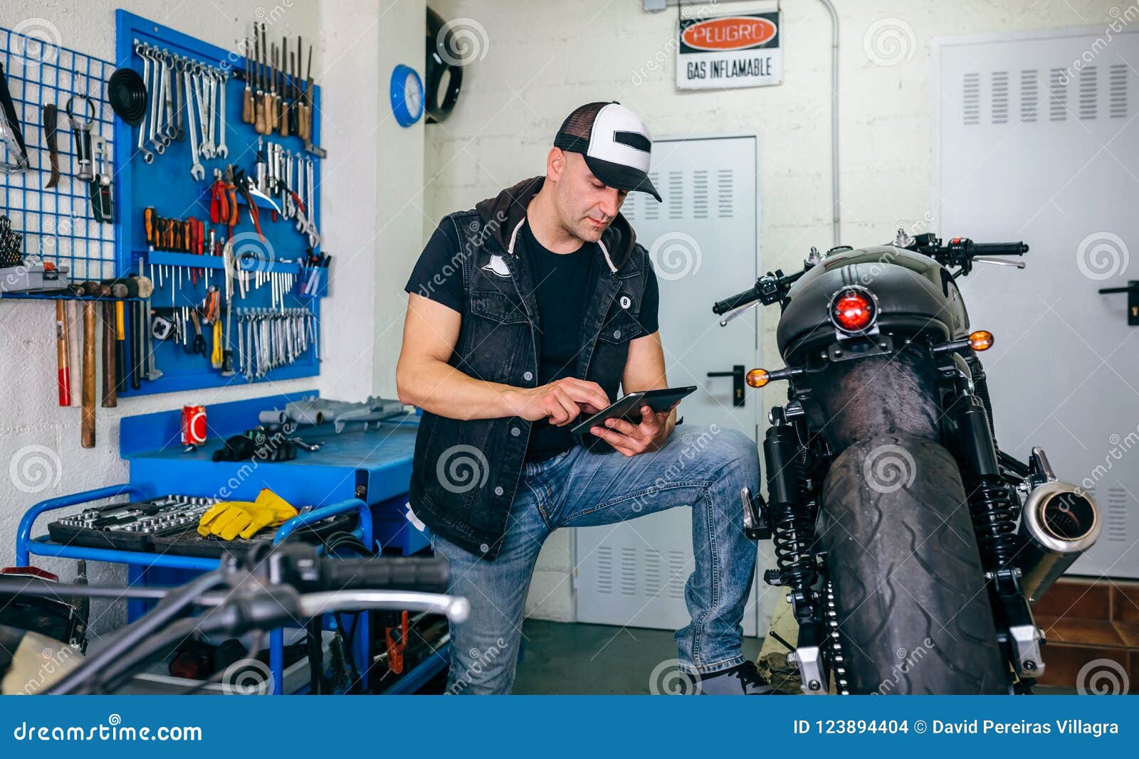 Mechanic Checking Custom Motorcycle with Tablet Stock Photo Image of