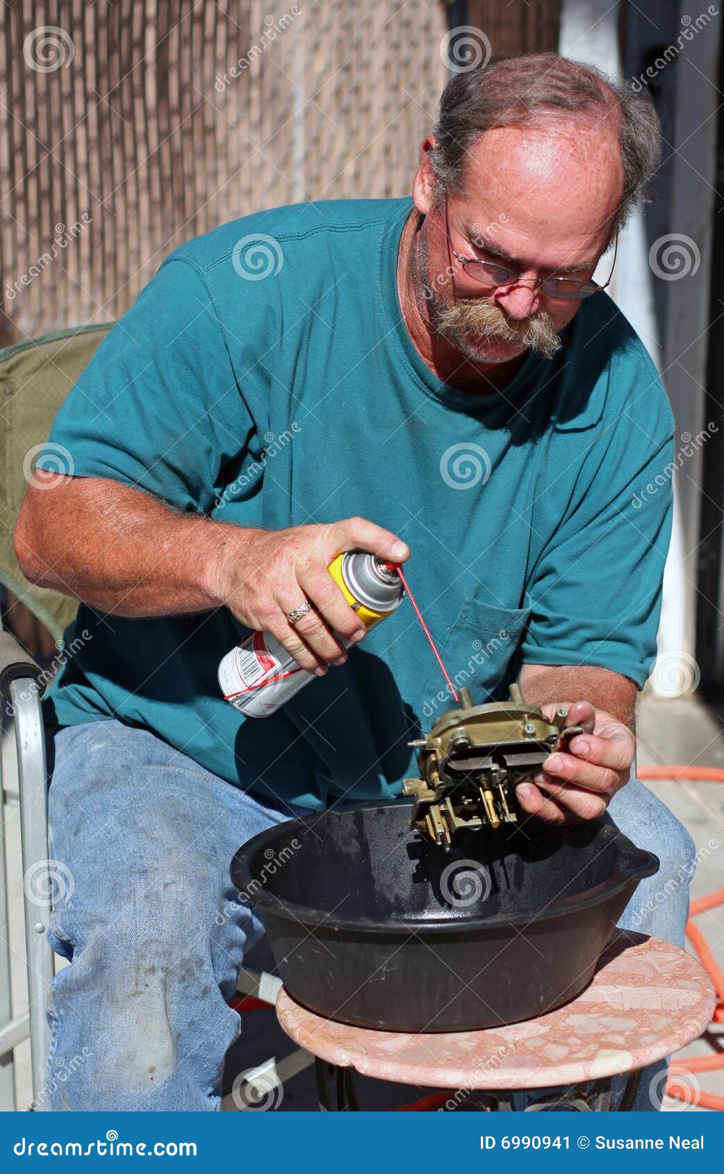 mechanic cleans carburetor