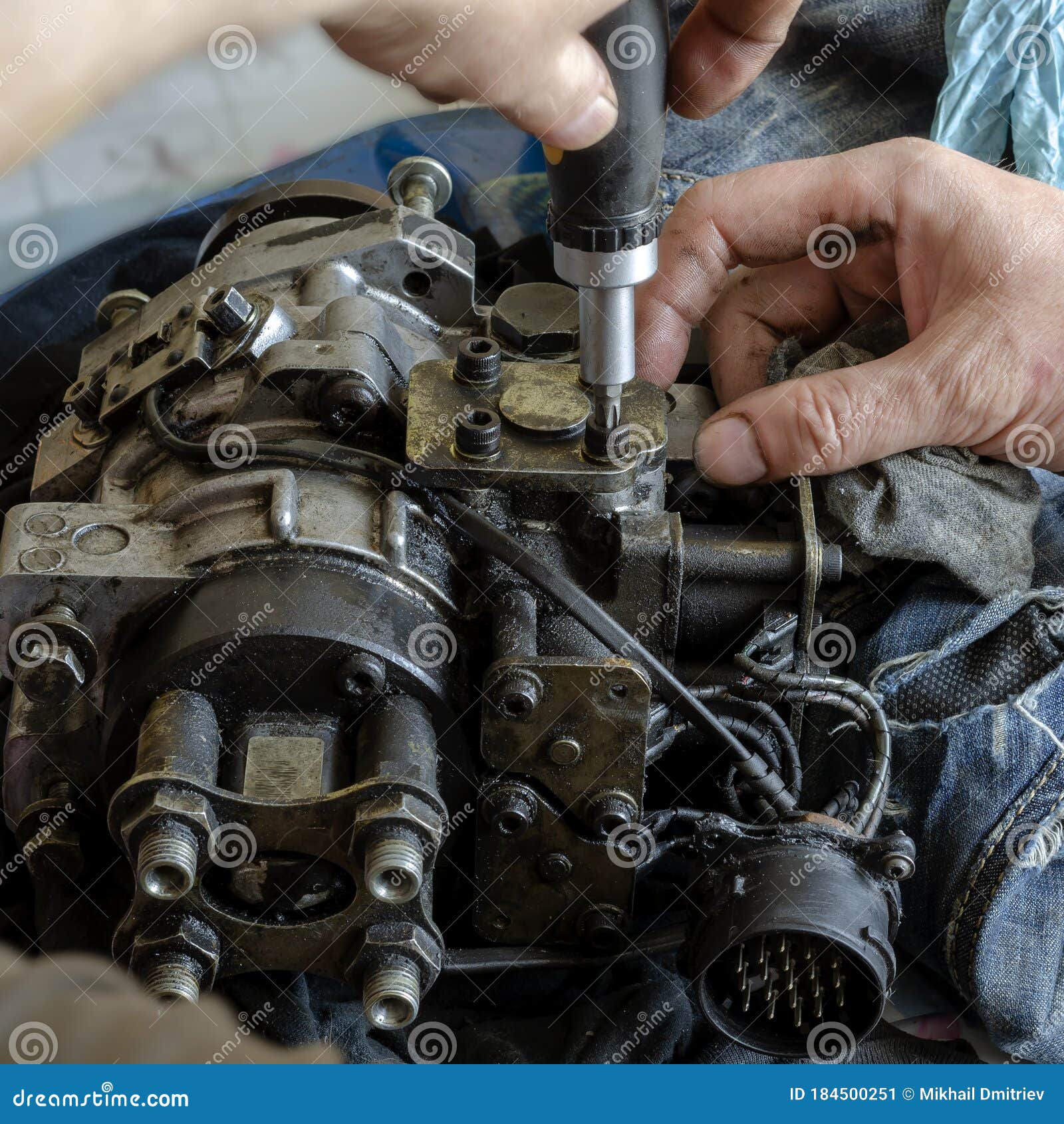 A Mechanic Disassembles and Detects a Fuel Injection Pump Stock Image