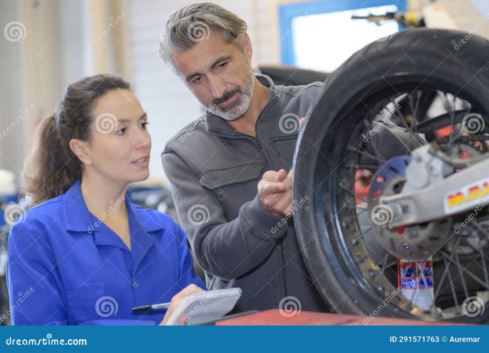Mechanic and Female Trainee Working with Tyre Stock Image Image of