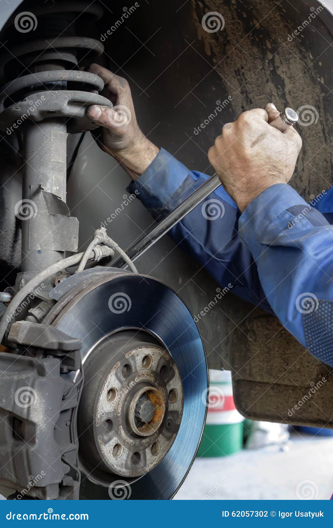 Mechanic fixes brakes stock photo. Image of mechanic 62057302