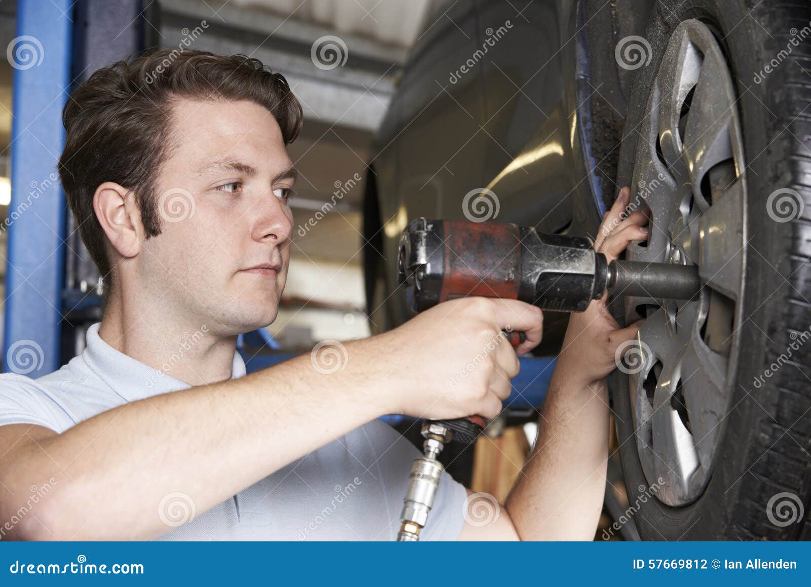 Mechanic in Garage Using Air Hammer on Car Wheel Stock Photo Image of