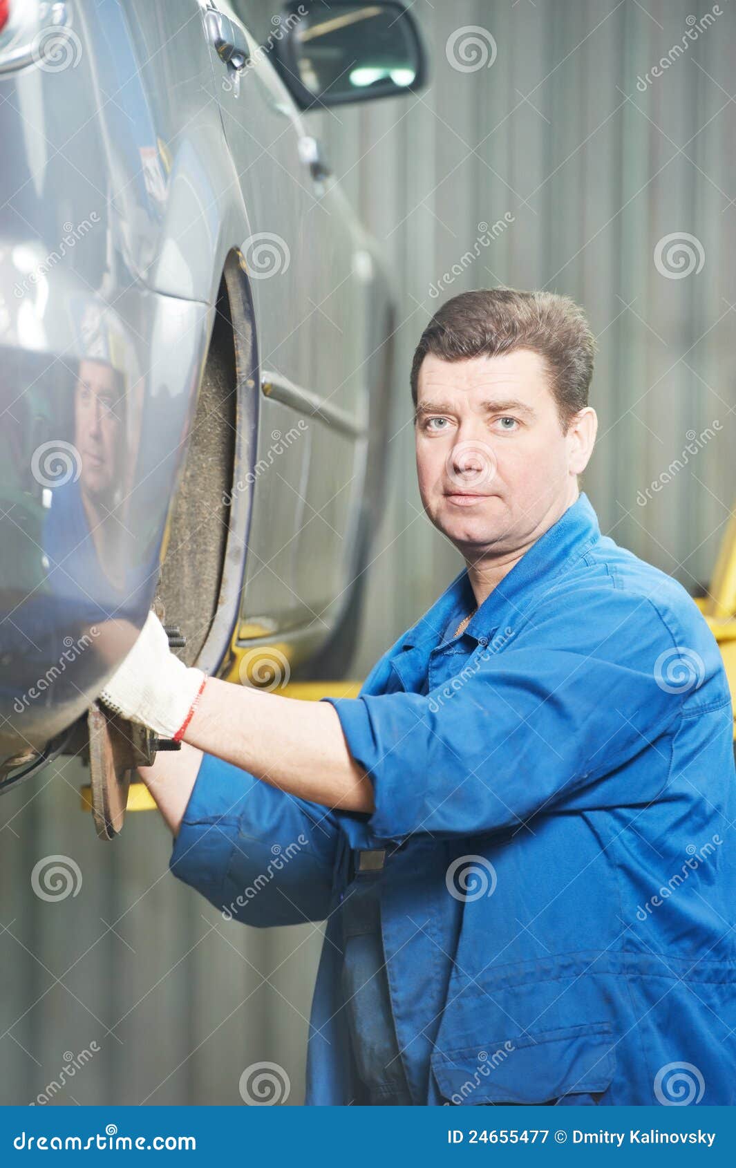Mechanic Installing Car Wheel at Service Station Stock Image Image of