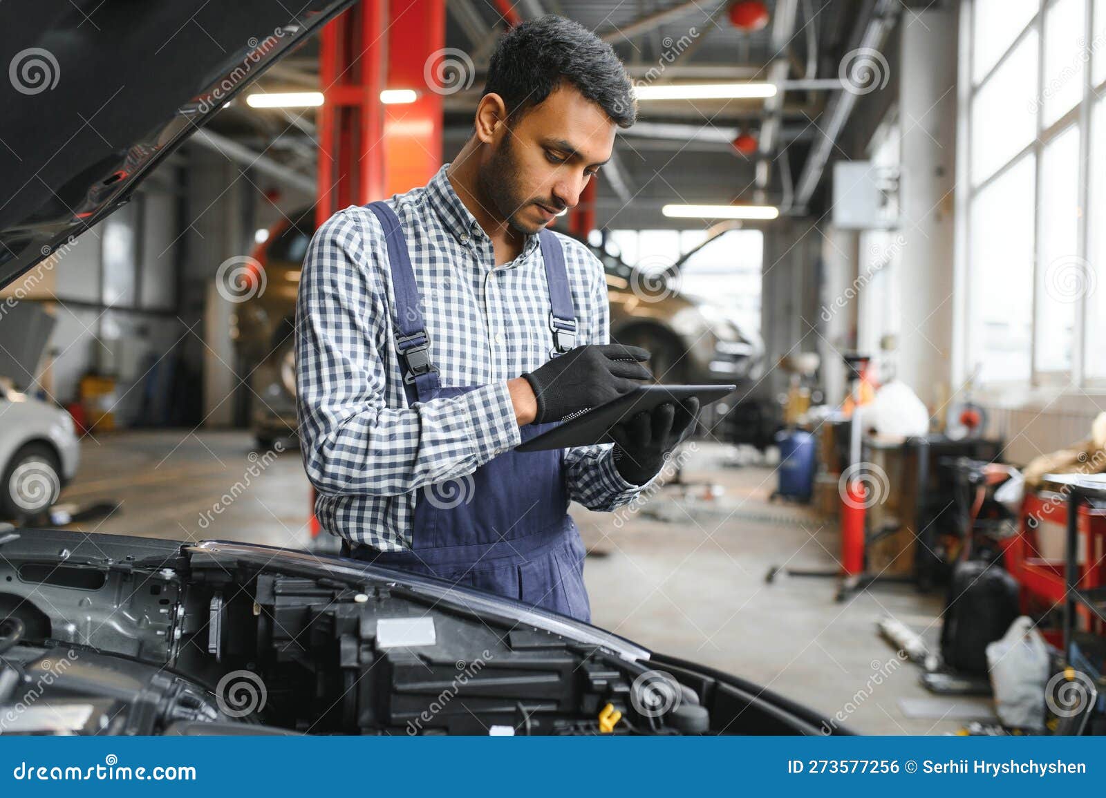 Mechanic Man Mechanic Manager Worker Using a Laptop Computer Checking
