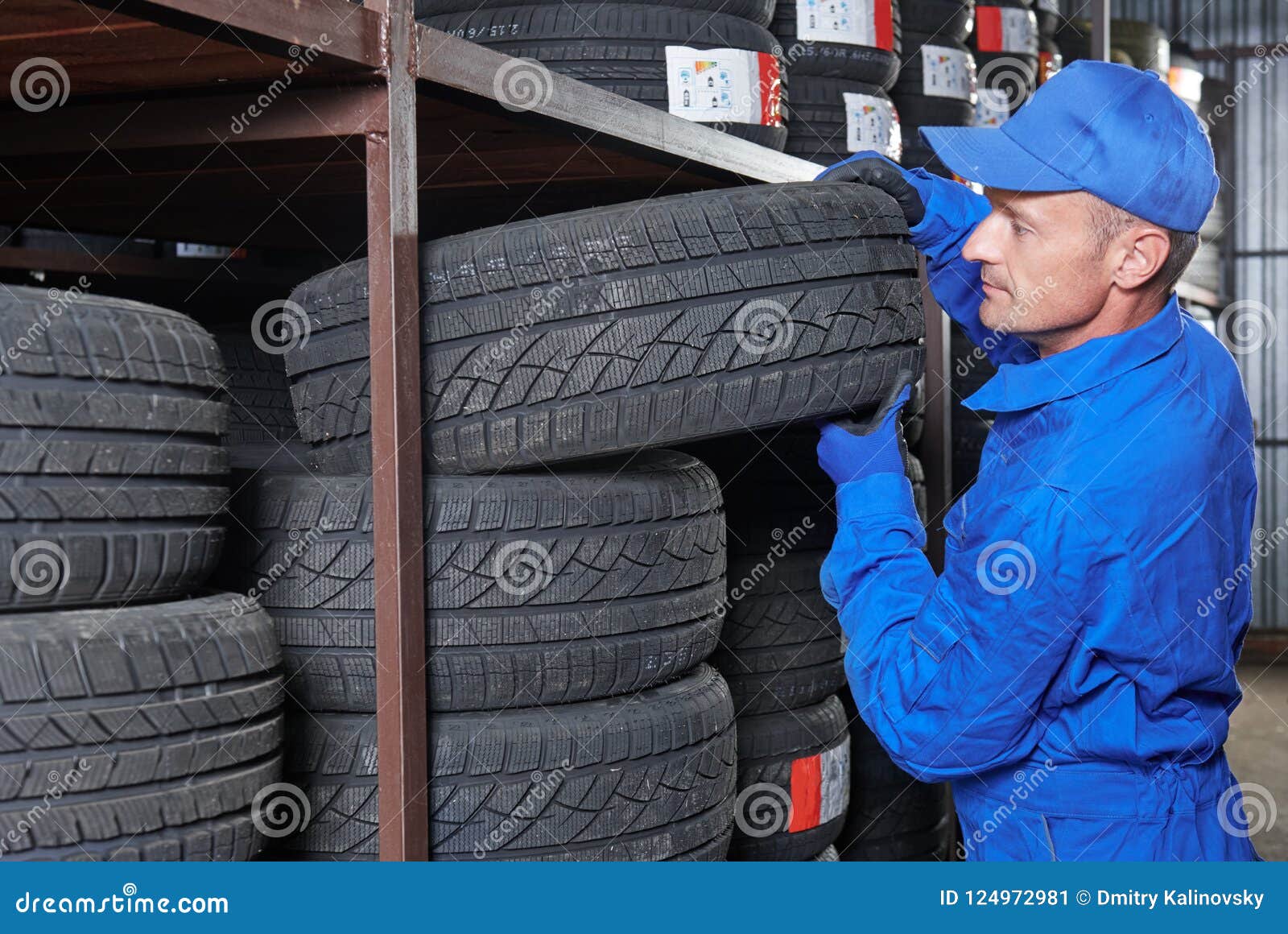 Mechanic Pulls Tire from the Tyre Store Warehouse Stock Image Image