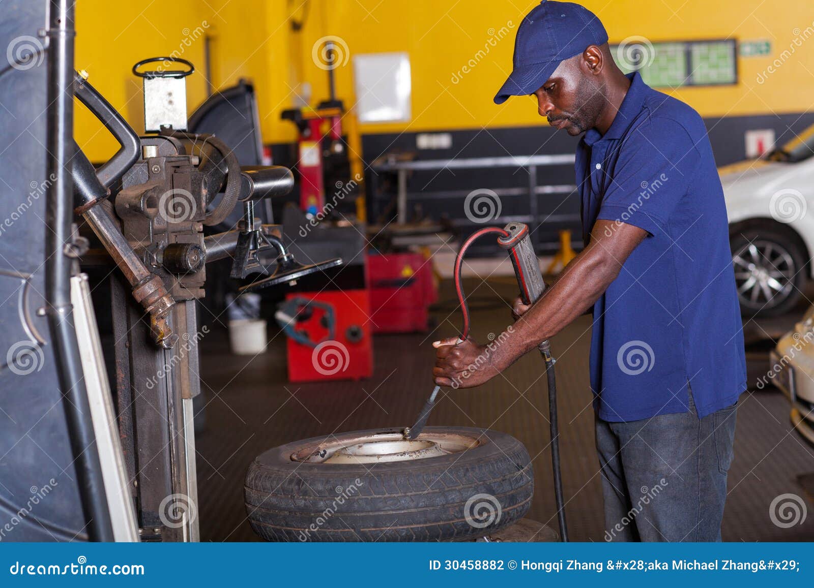 Mechanic pumping tyre stock photo. Image of employment 30458882