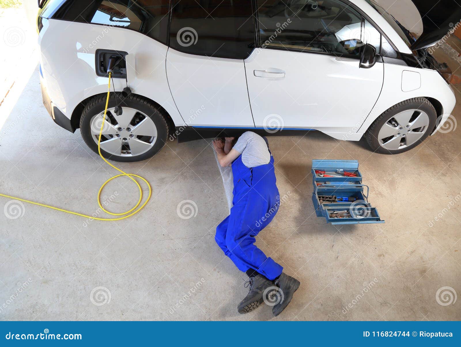 Mechanic Repairing an Electric Driven Car at Garage Stock Photo Image