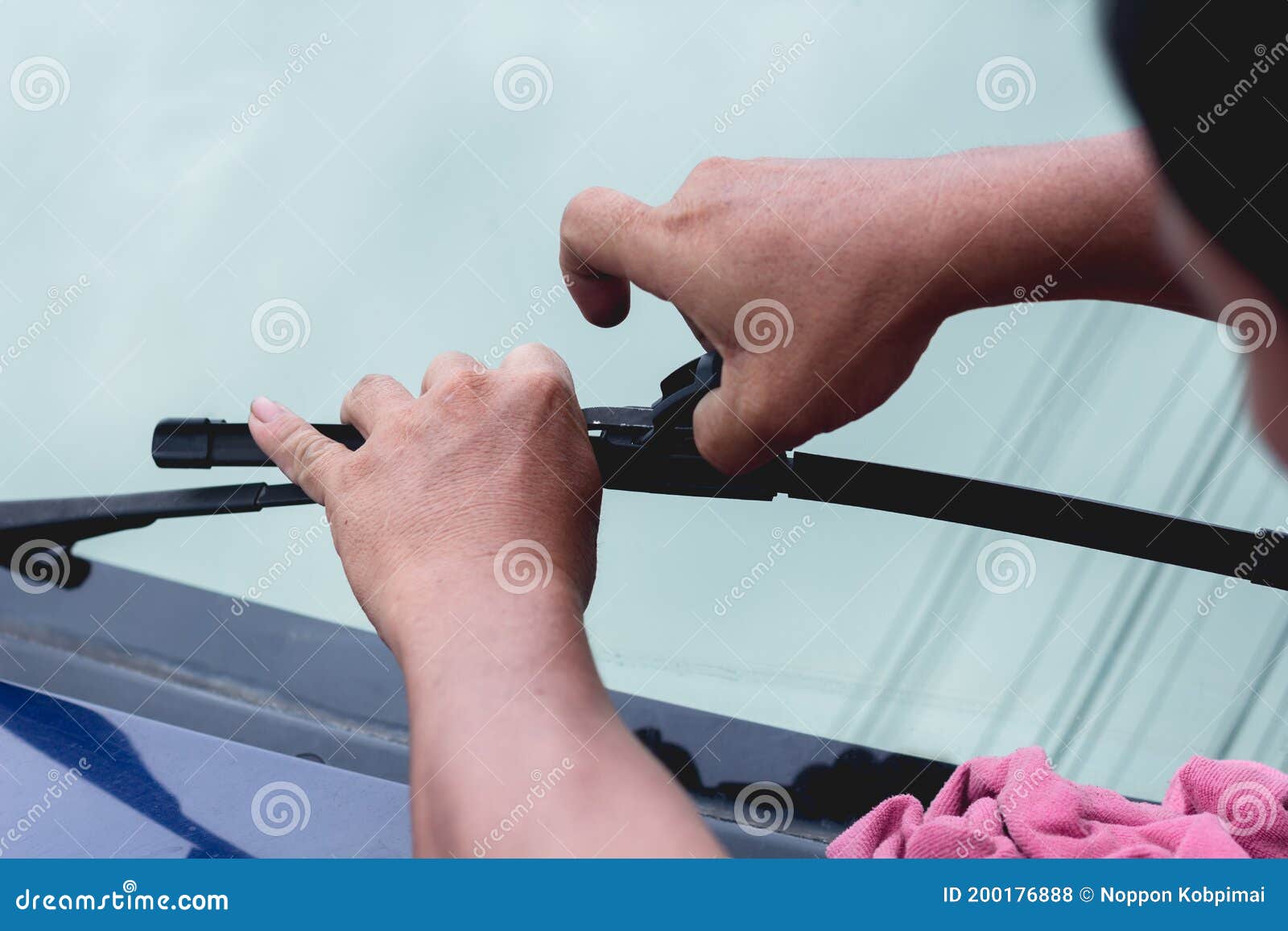 Mechanic Replace Windshield Wipers on Car. Replacing Wiper Blades Stock