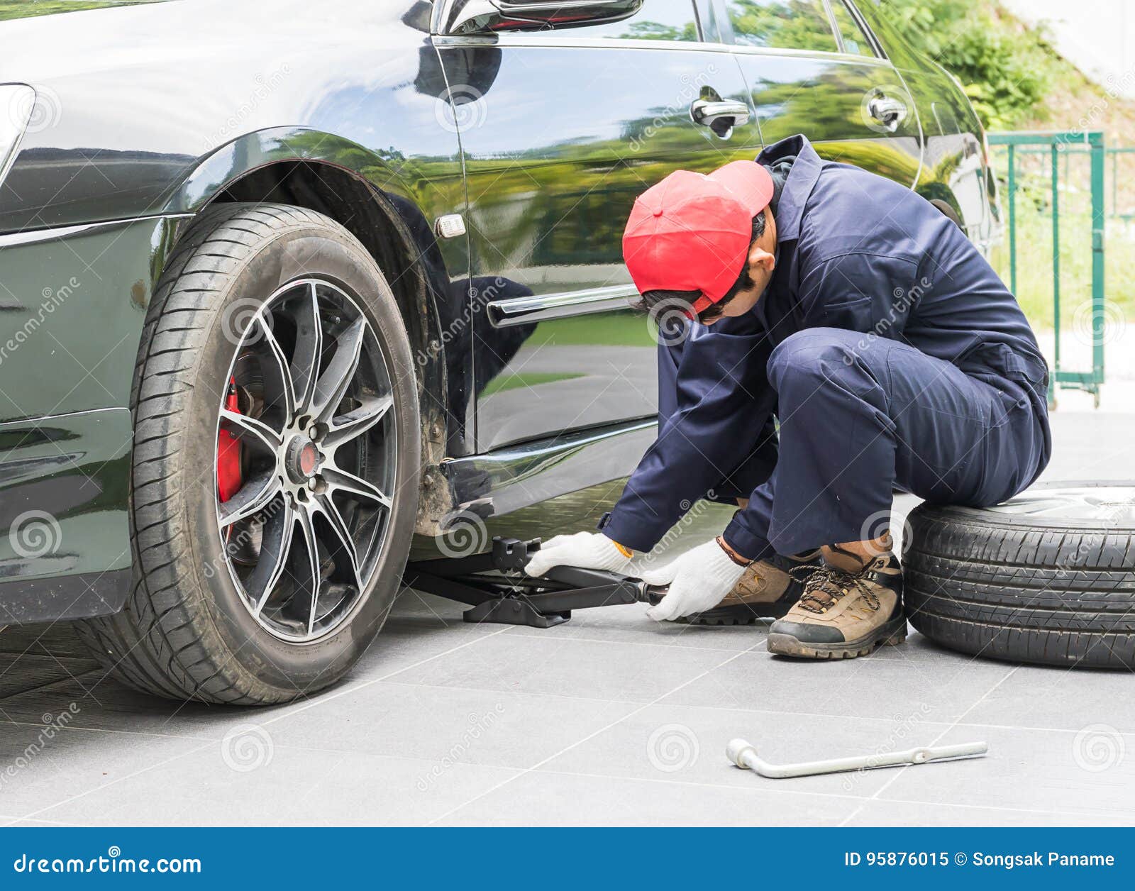 Mechanic Replacing Lug Nuts Changing Tires on Vehicle Stock Image