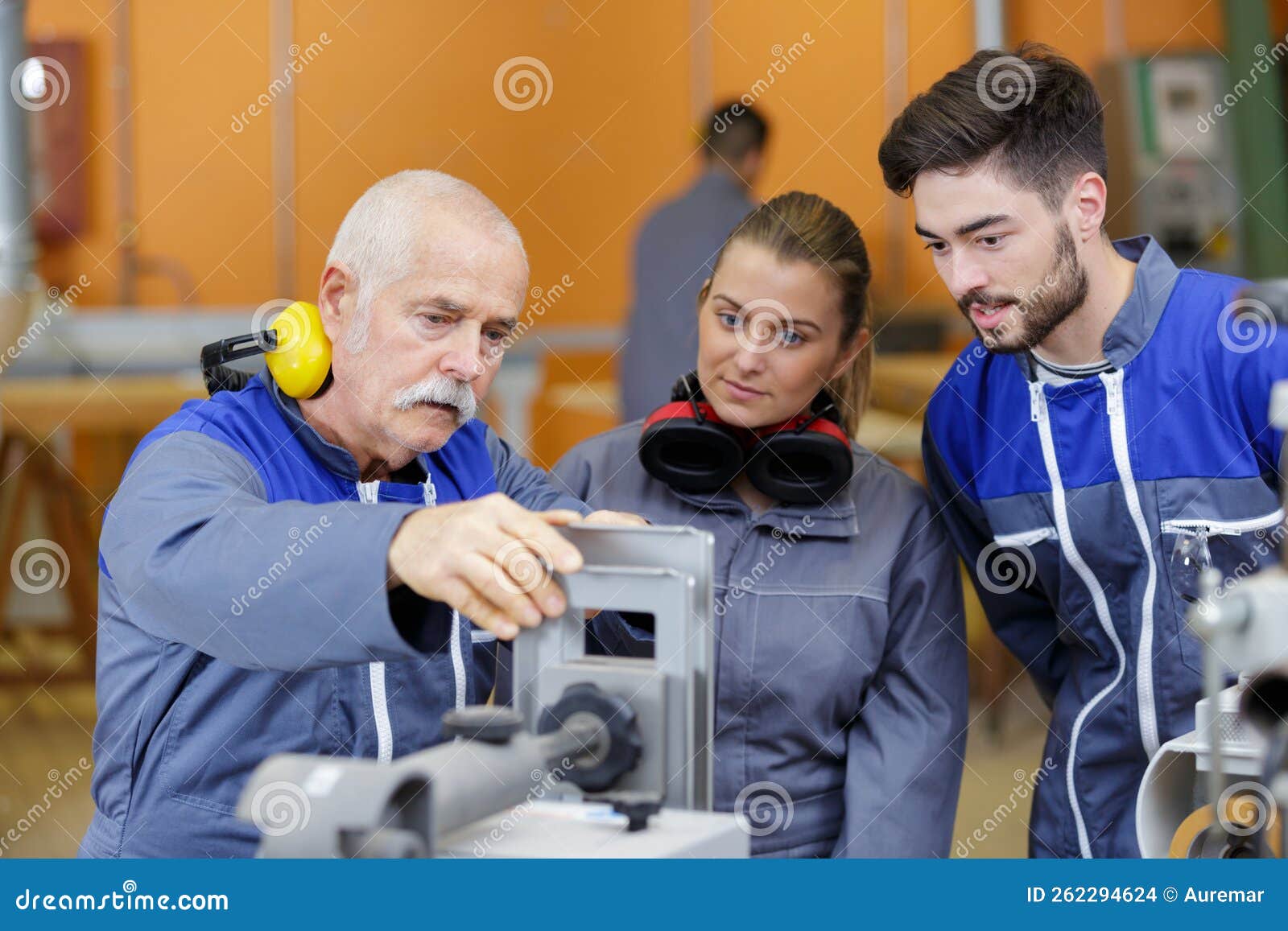 mechanic showing engines to apprentices