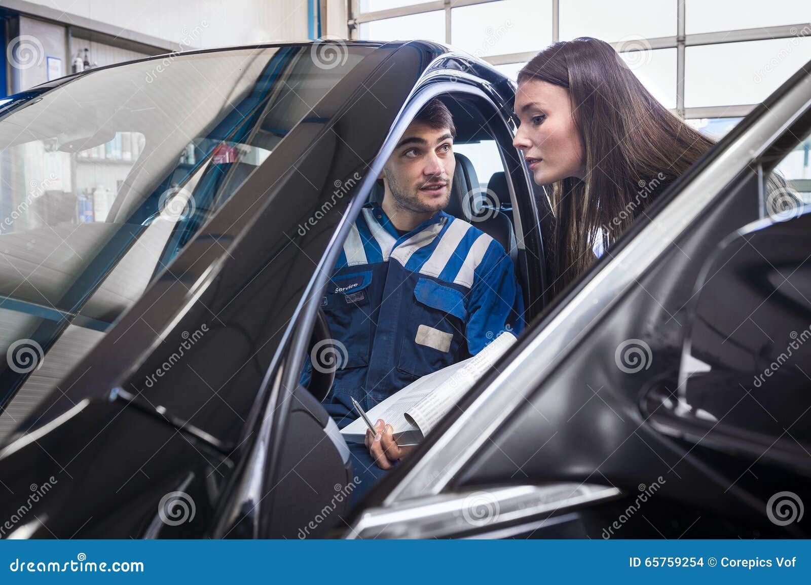 mechanic sits in the serviced car and explains