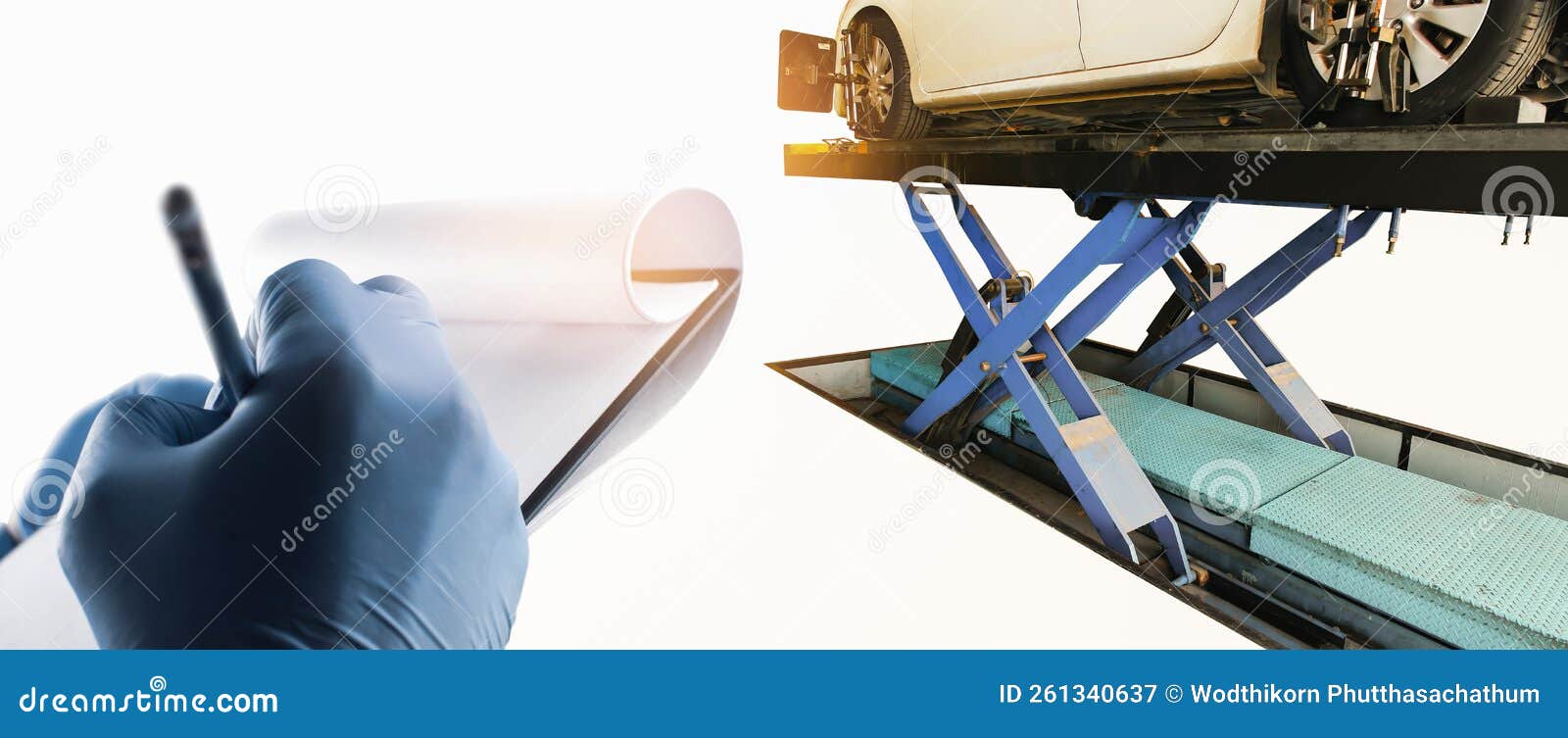 The Mechanic is Taking Notes on Paper for Analyzing the Car Problems of