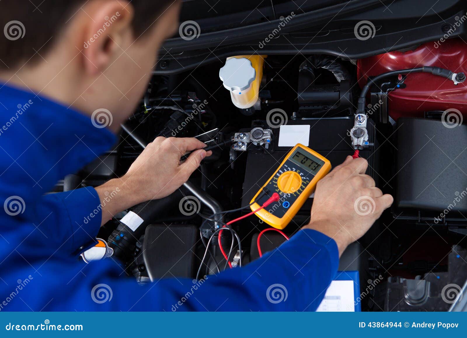 mechanic testing car battery