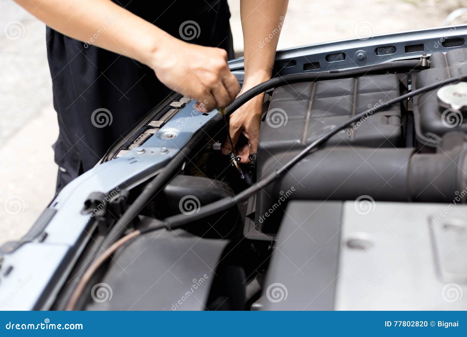Mechanic Testing Headlight Bulb with Electric Screwdrivers Stock Photo