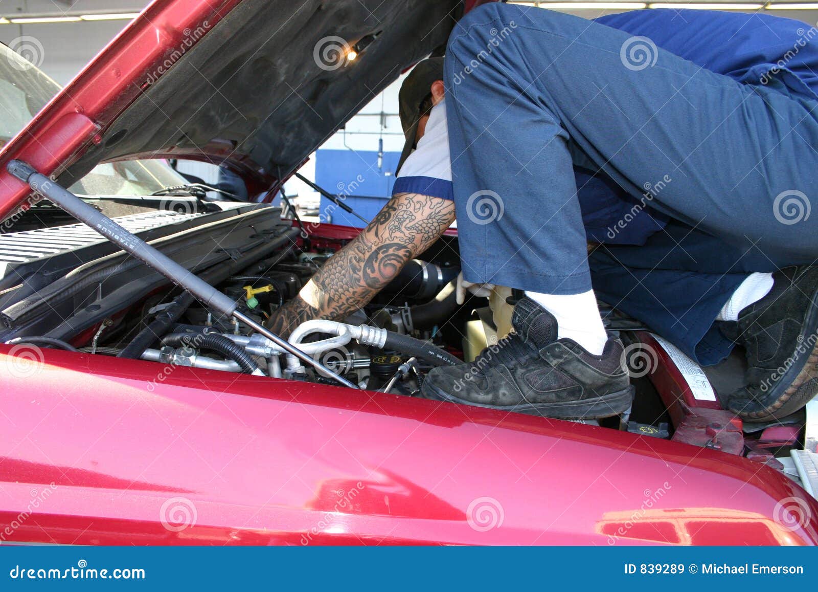Mechanic under the hood stock image. Image of technician 839289
