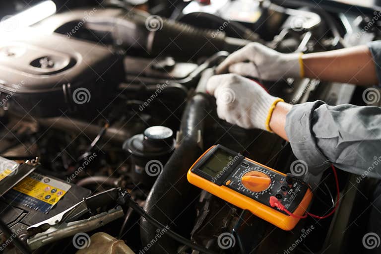Mechanic Using Multimeter stock image. Image of technician 287885199