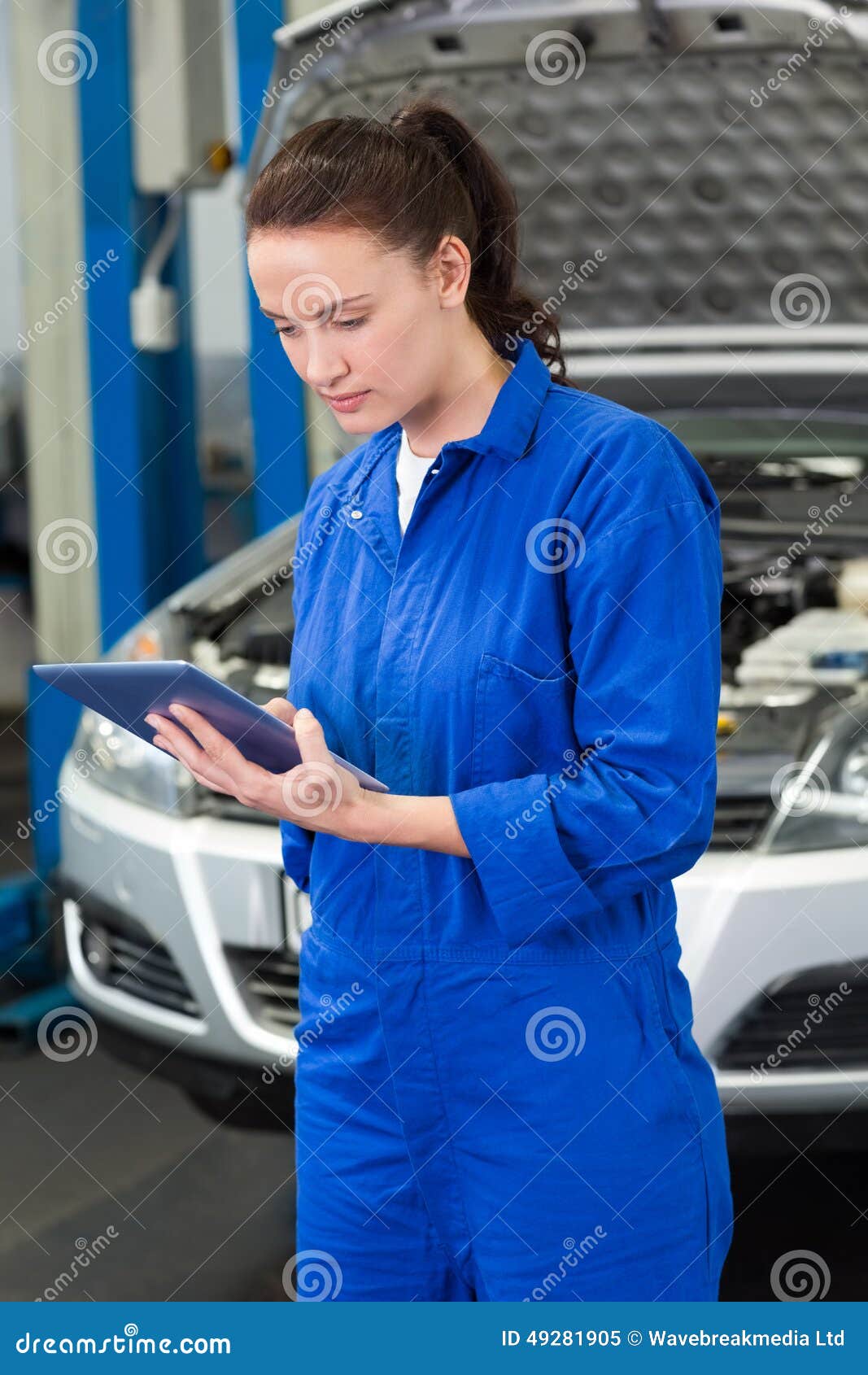 Mechanic using a tablet pc stock image. Image of person 49281905