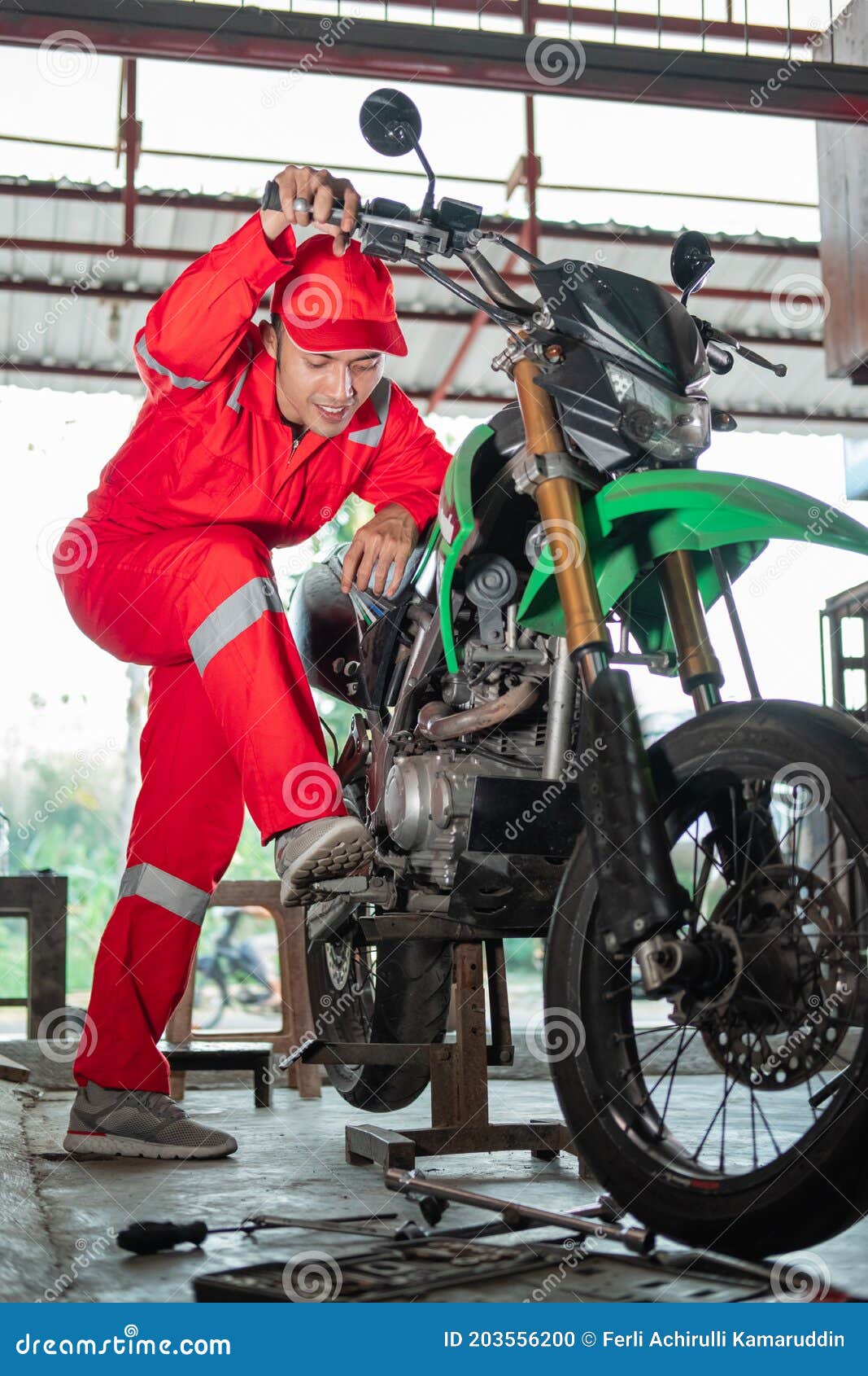 Mechanic in Wearpack Checking Dirt Bike Engine Stock Photo Image of