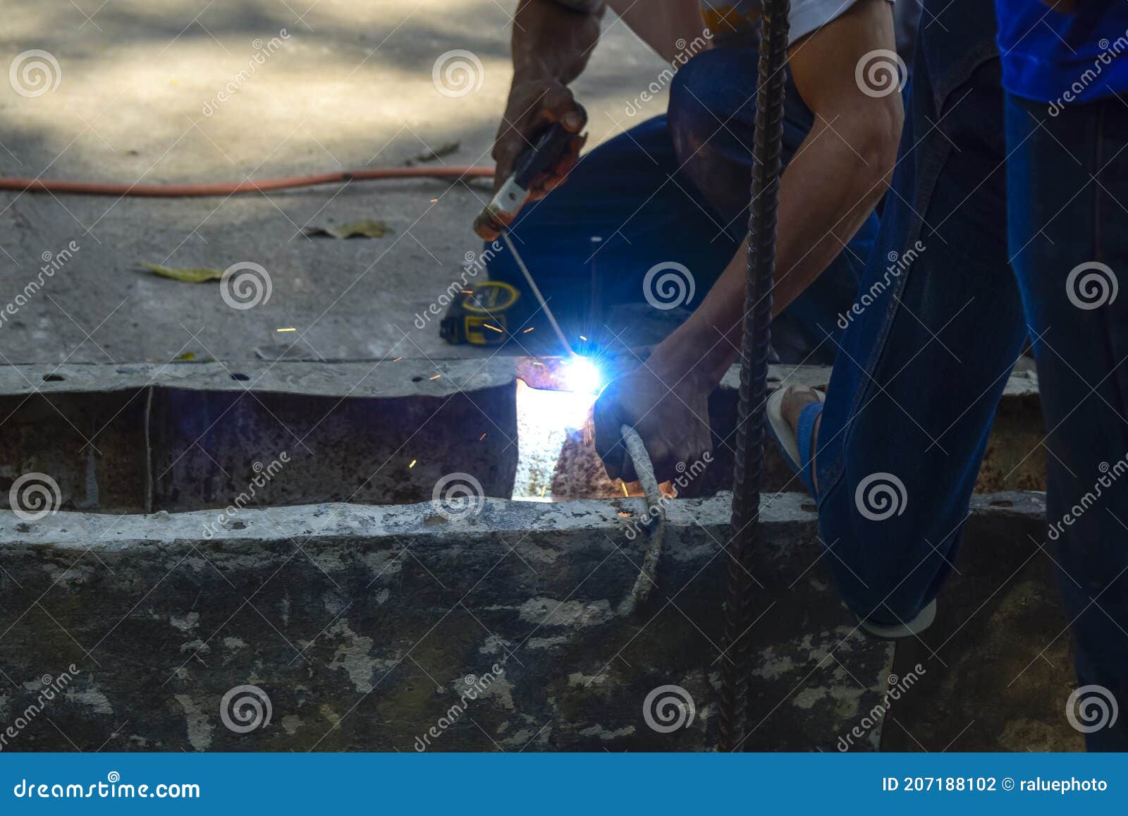 Mechanic Workers are Welding Iron without Protective Gloves Stock Photo