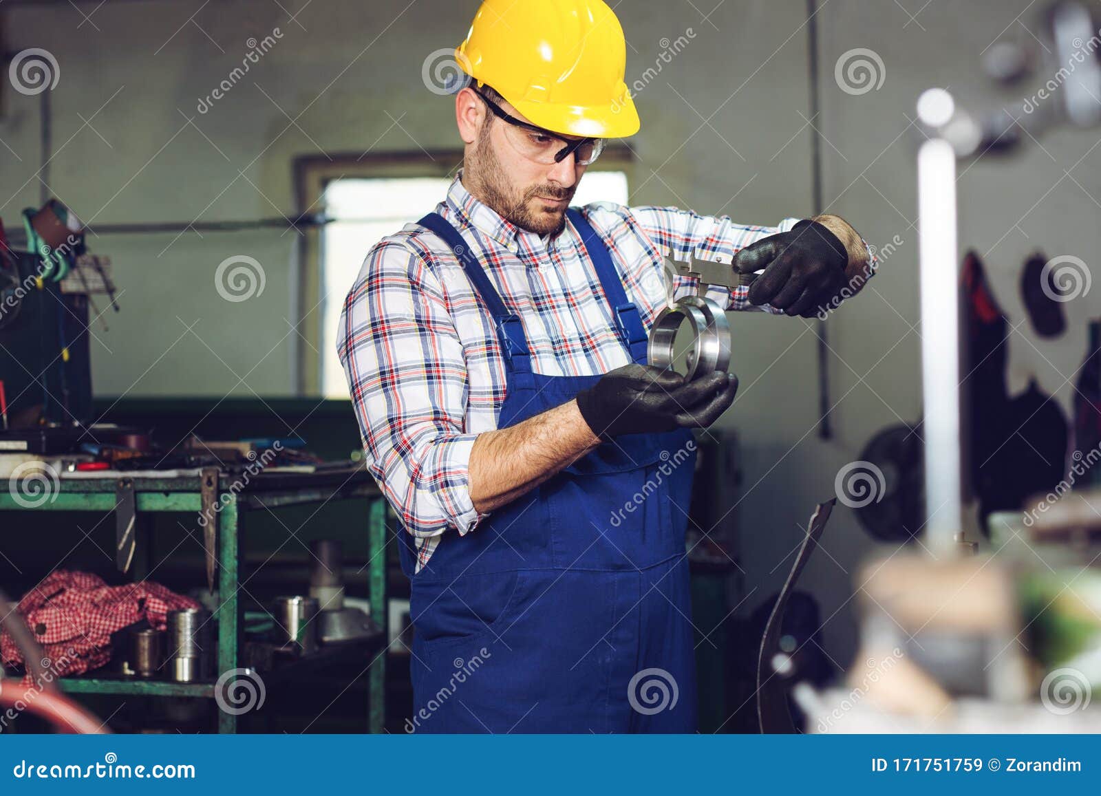 Mechanical Technician Measuring with Caliper in Stock Image