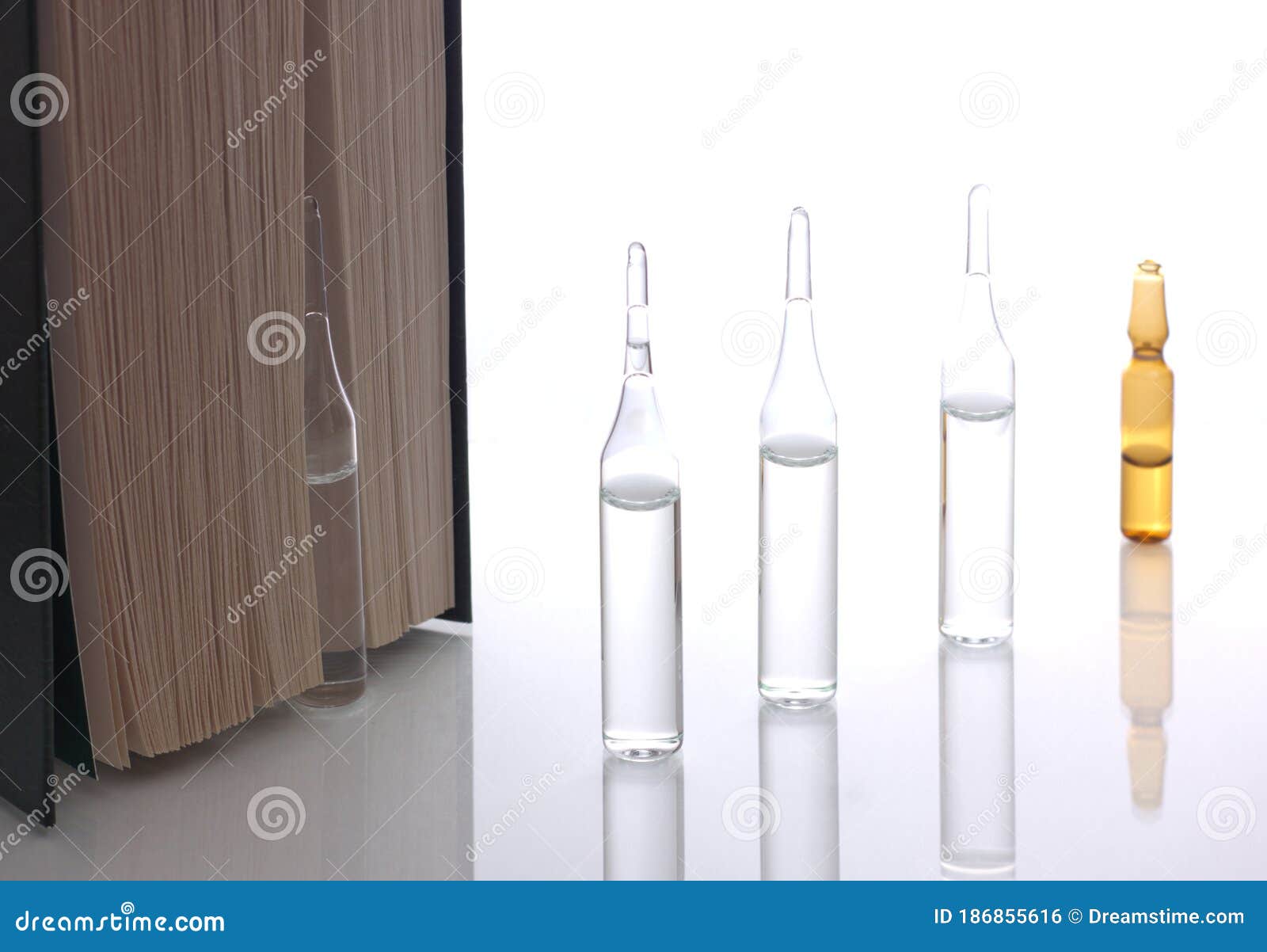 Medical Ampoules on a White Background with a Book Stock Photo Image