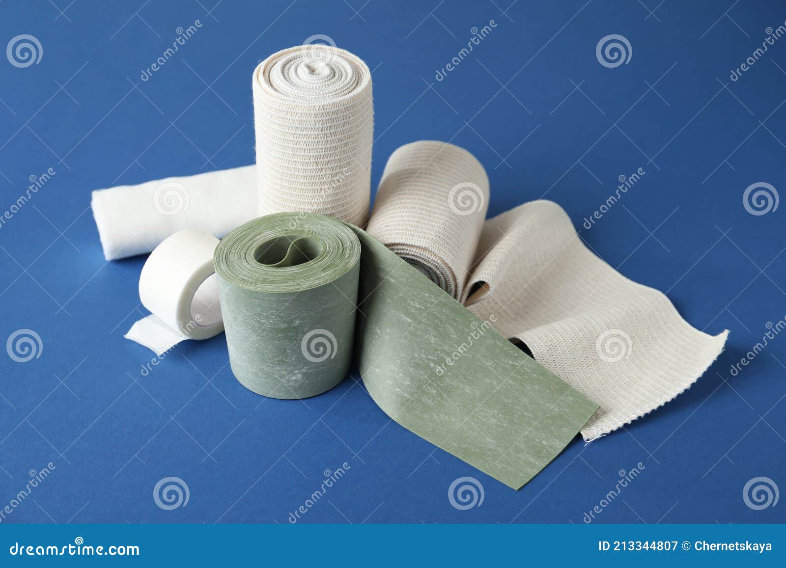 Medical Bandage Rolls and Sticking Plaster on Blue Background Stock