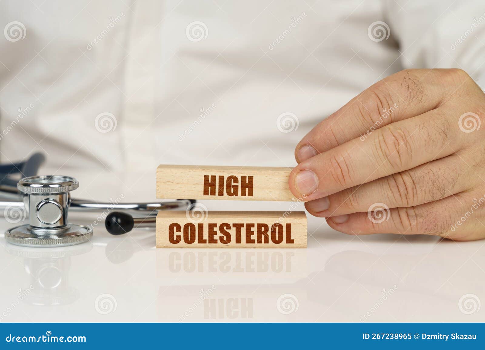 on a white surface, a stethoscope and wooden plates with the inscription - high colesterol