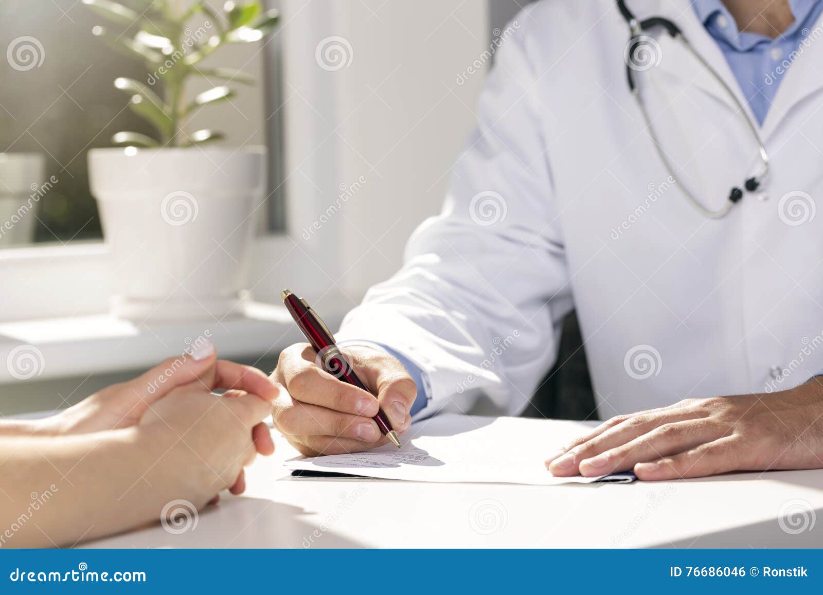 Medical Consultation Doctor and Patient Sitting by the Table Stock
