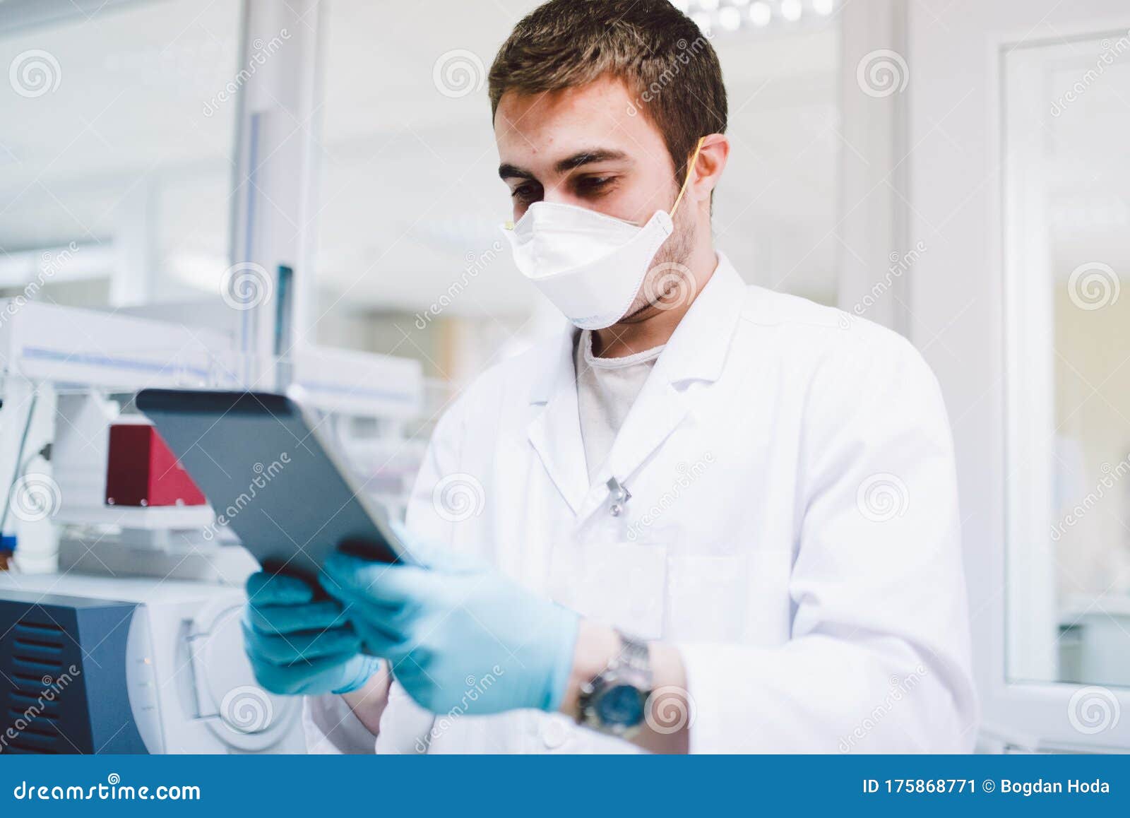doctor in the laboratory with dna machinery and tablet analysing samples of covid19 infectious disease. coronavirus