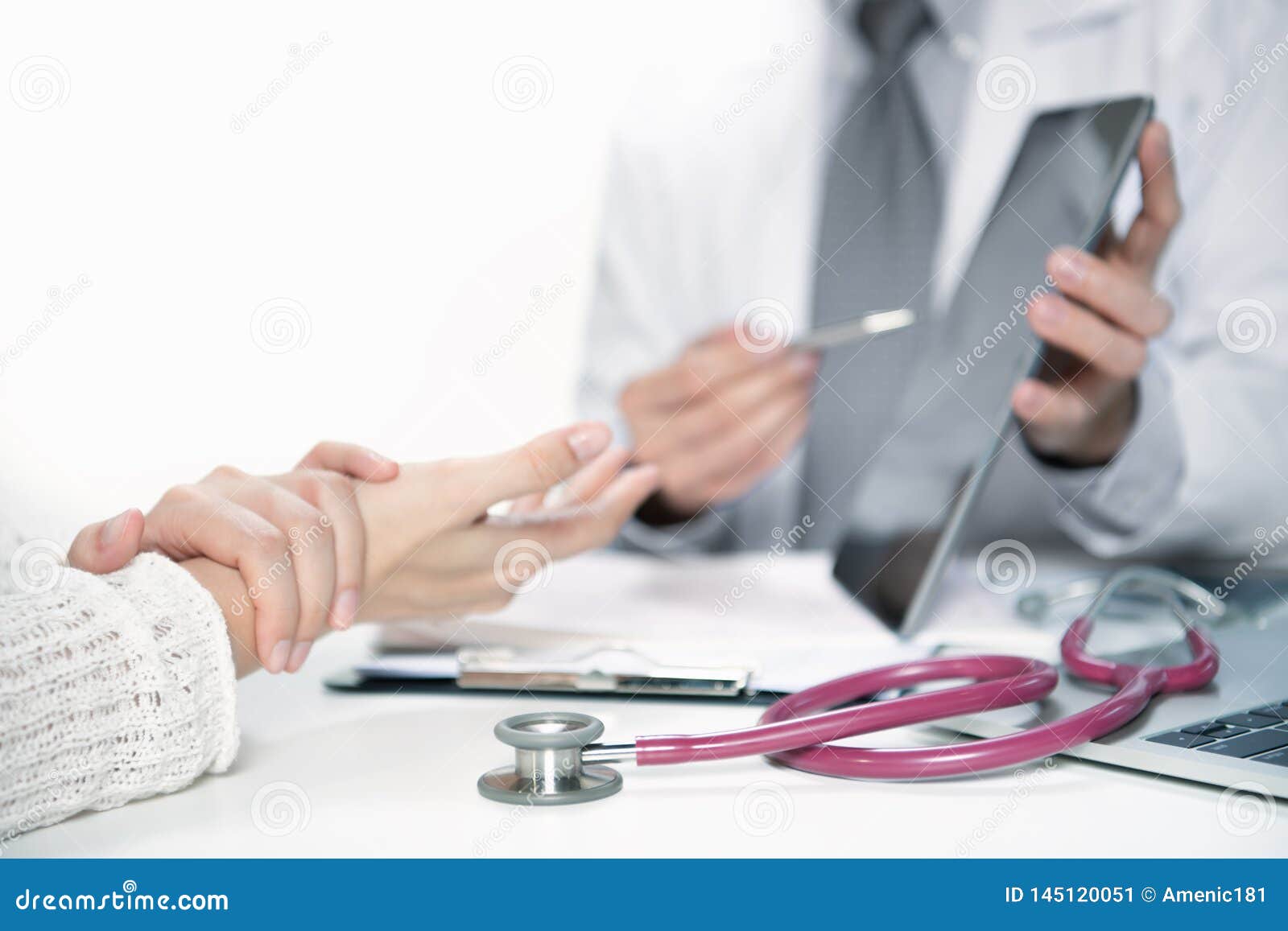 medical doctor and patient discussing and consulting in hospital examination room