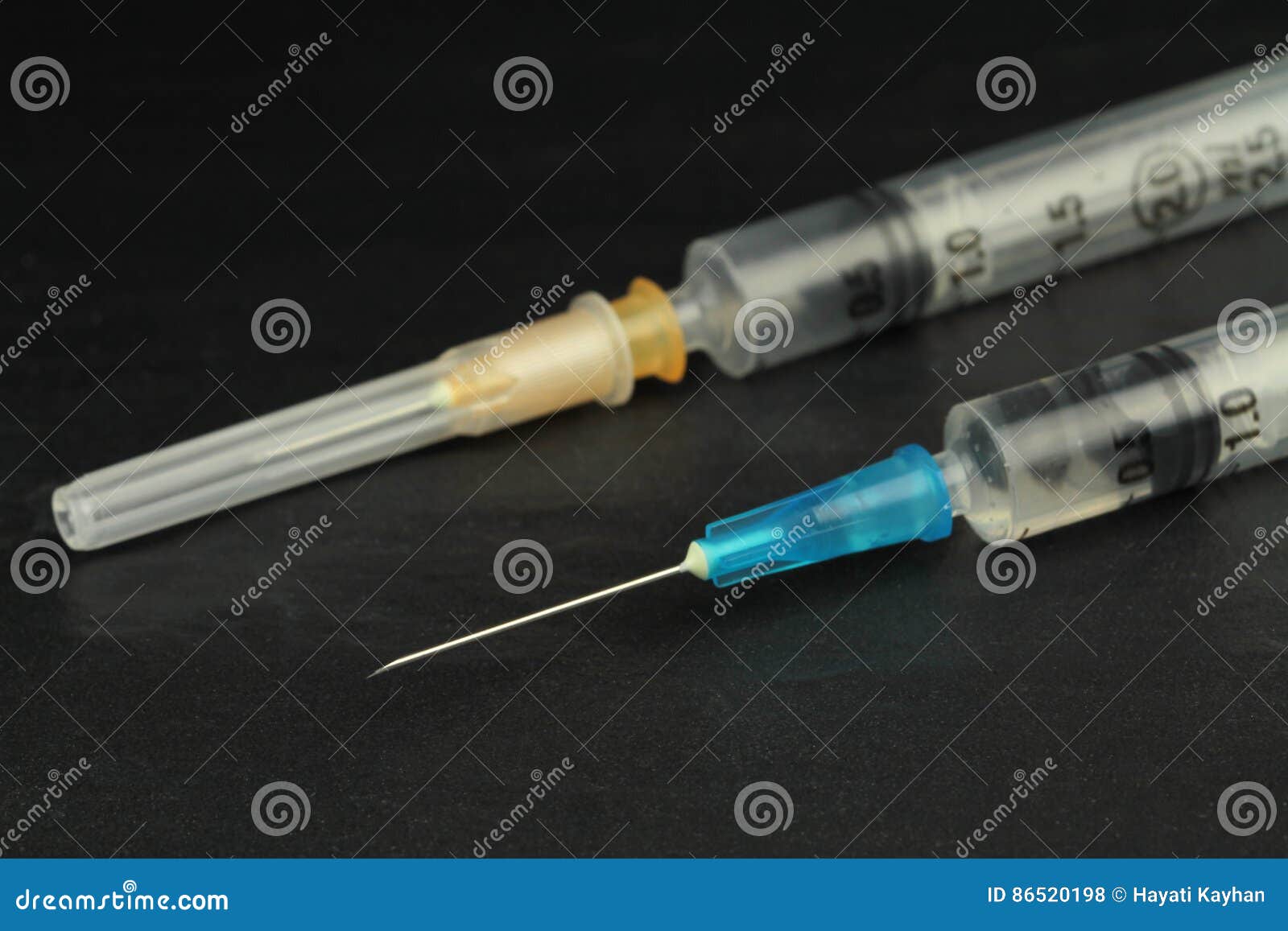 medical injection syringe with solution on black background