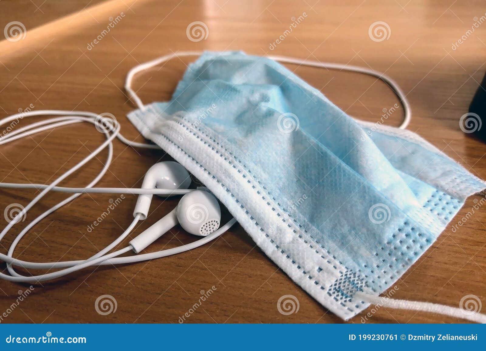 medical mask and headphones on the desktop. rest from work. prevention of coronavirus