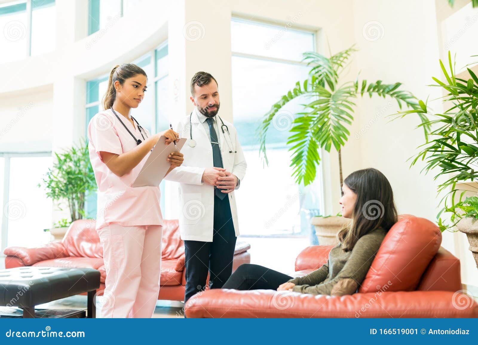 medical professionals communicating with woman at hospital