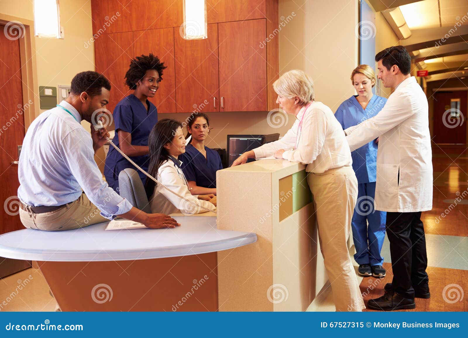 medical staff at busy nurse's station in hospital