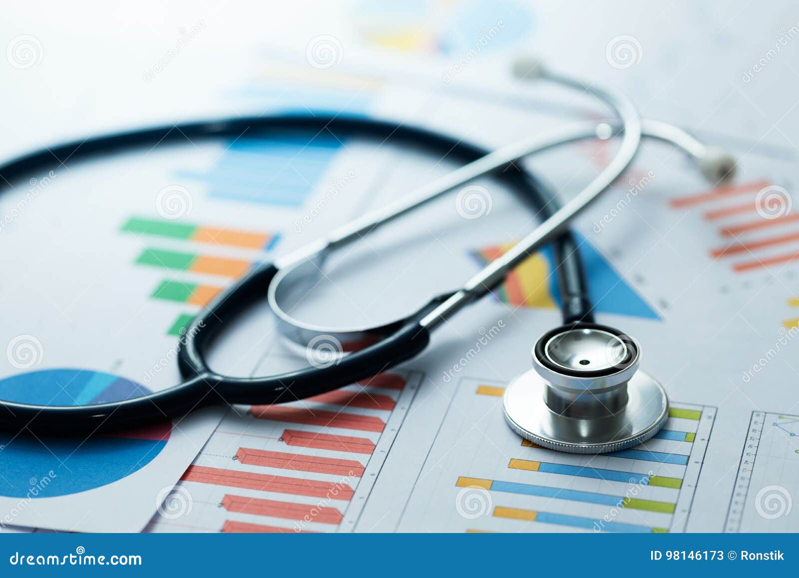 medical statistics and graphic charts with stethoscope