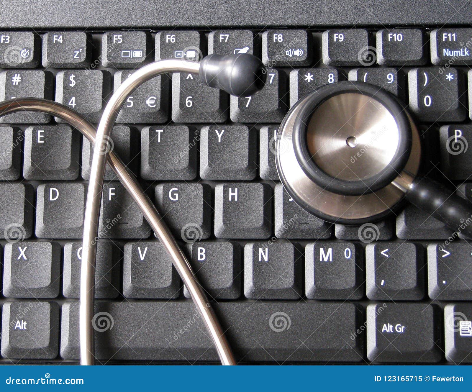 medical stethoscope on top of laptop computer keyboard. illustrative of healthcare and technology, informatics, bioinformatics