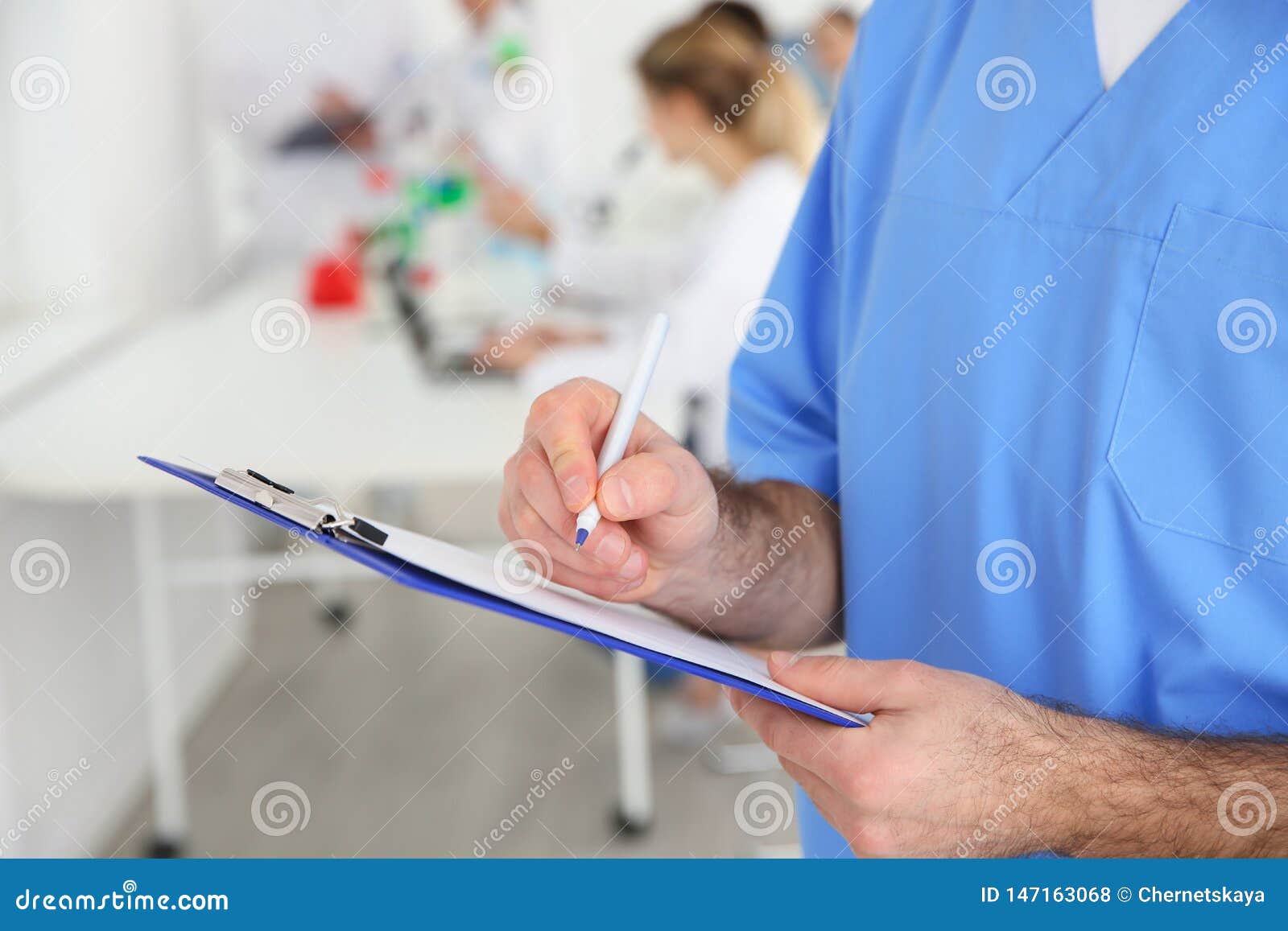 Medical Student with Clipboard Working in Scientific Laboratory Stock